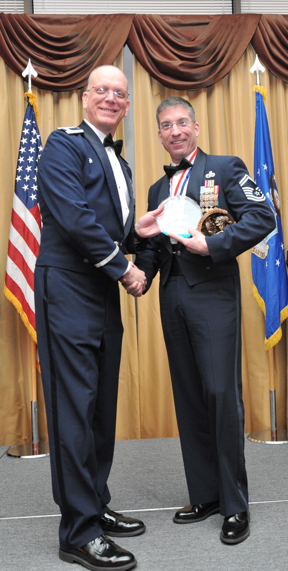 Senior Master Sgt. Christopher Hofrichter of the 514th Maintenance Operations Squadron receives the award for Senior Noncommissioned Officer of the Year at the 14th Annual Awards Banquet held at Tommy B’s Community Center here Jan. 11. Members here are nominated from within their ranks to be recognized at the annual event. Winners are then forwarded to compete with other units within the numbered Air Force (U.S. Air Force photo/Senior Airman Chelsea Smith).