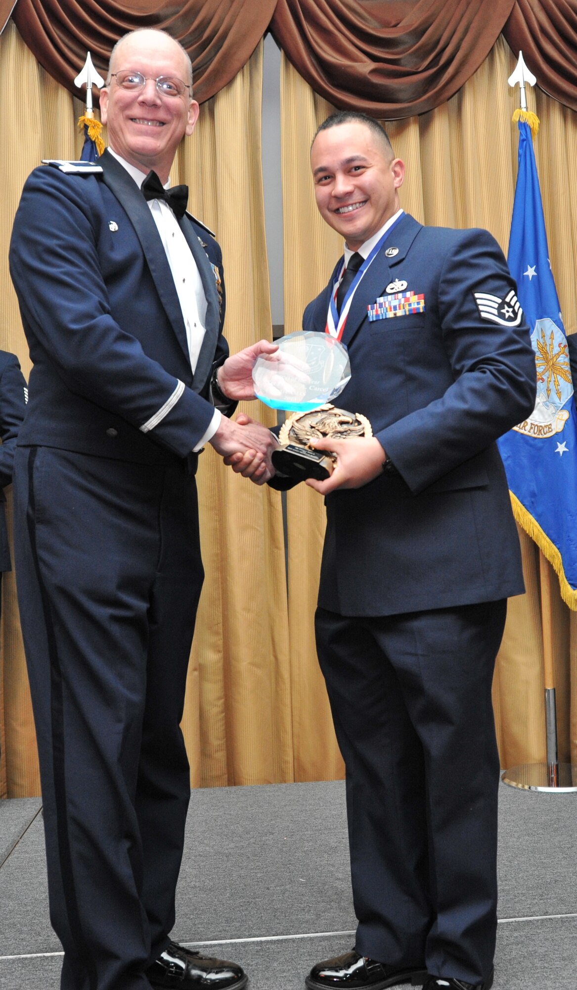 Staff Sgt. Francis A. Carcel, right, of the 514th Aircraft Maintenance Squadron, receives the award for Noncommissioned Officer of the Year at the 14th Annual Awards Banquet held at Tommy B’s Community Center here Jan. 11. Col. Michael Underkofler, 514th AMW commander, presented 12 prestigious awards at the ceremony to recognize the outstanding achievements of Freedom Wing Airmen and civilian personnel, as well as the efforts of 514 AMW squadrons and groups (U.S. Air Force photo/Senior Airman Chelsea Smith).