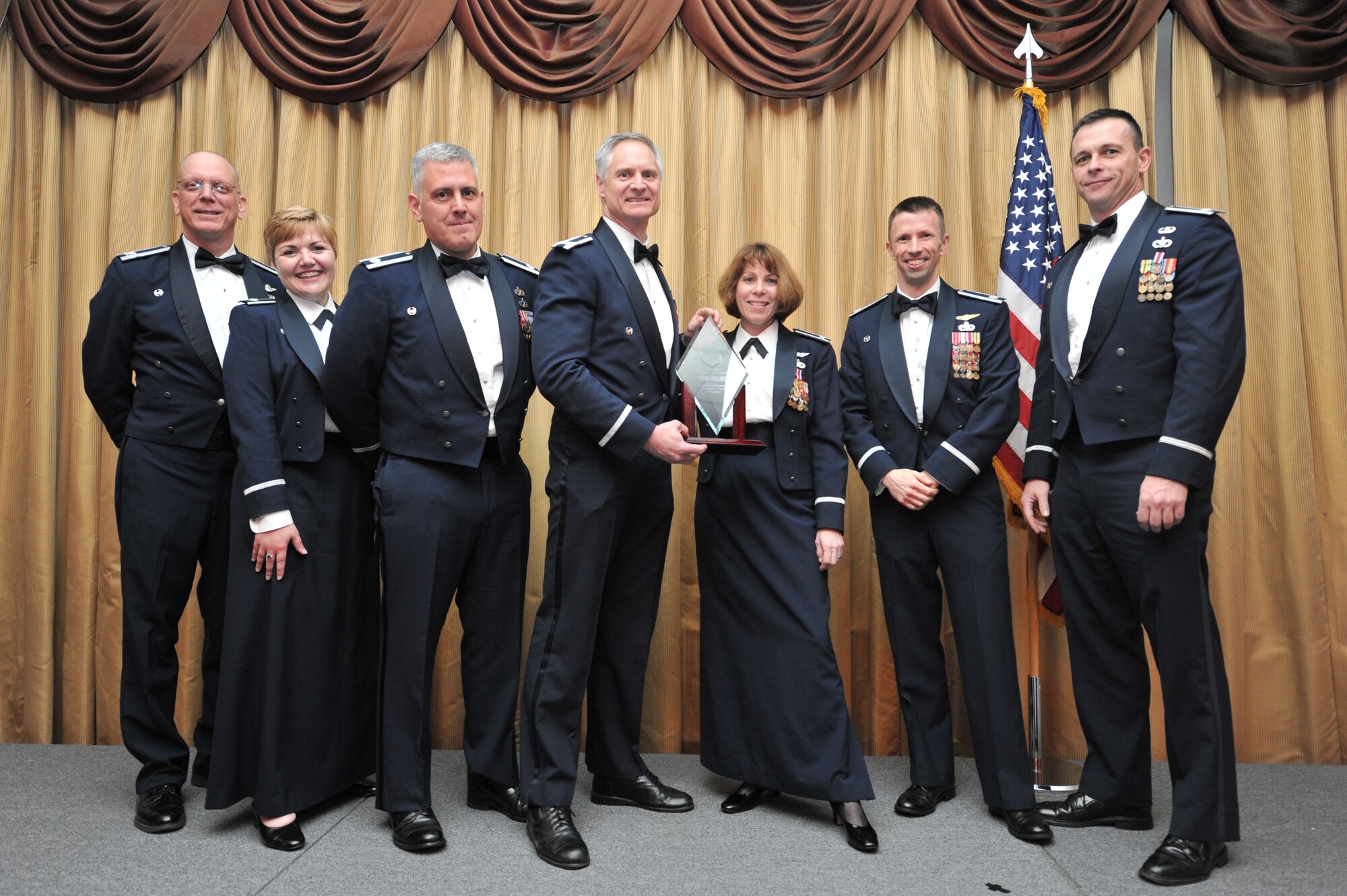 Col. Cynthia A. Wong, 514th Mission Support Group commander, and fellow members receive the group-level Freedom Wing award at the 14th Annual Awards Banquet held at Tommy B’s Community Center here Jan. 11 (U.S. Air Force photo/Senior Airman Chelsea Smith).
