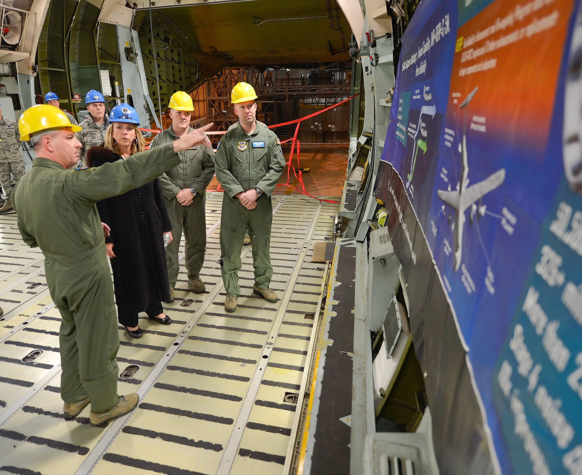 Senior Master Sgt. Brandon Trolinger, a C-5M flight engineer from the 9th Airlift Squadron, briefs Secretary of the Air Force Deborah Lee James during a tour of a C-5M undergoing isochronal inspection during her visit Jan. 10, 2014, Dover  Air Force Base, Del. During her visit, James toured the aerial port, the Air Force Mortuary Affairs Operations and statics of the C-5M Super Galaxy and C-17A Globemaster III. (U.S. Air Force photo/Greg L. Davis)