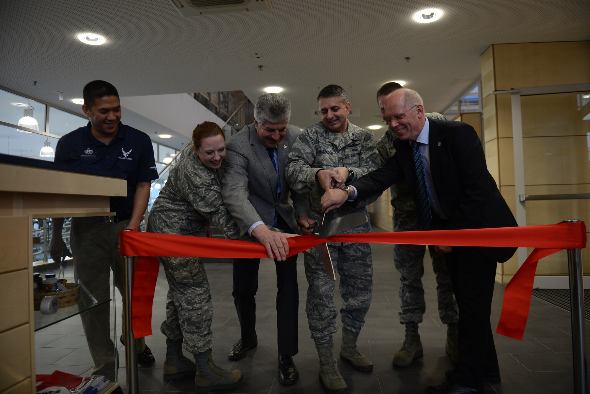 SPANGDAHLEM AIR BASE, Germany – Spangdahlem community leadership cut a ceremonial ribbon symbolizing the opening of the new fitness center Jan. 13, 2014. The building is energy-efficient, has motion-sensor lighting with large windows for natural lighting and efficient heating and cooling systems for extreme weather. (U.S. Air Force photo by Senior Airman Gustavo Castillo/Released)