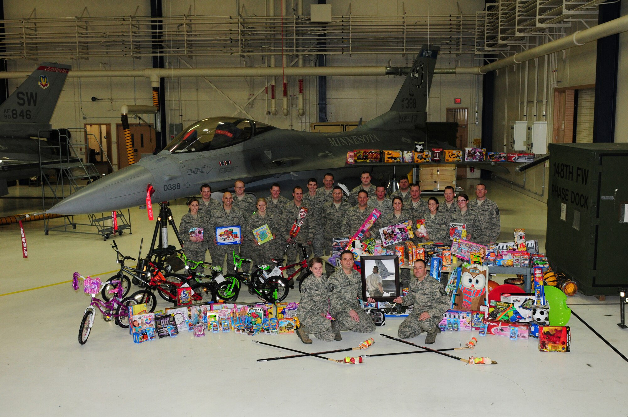 U.S. Air Force F-16C Fighting Falcon crew chiefs and other members of the 148th Fighter Wing display the children's toys that were purchased as the result of the Inaugural Ryan Ewald Memorial Toy Drive, December 16, 2013.  The Wing wide Toy Drive raised over 3,000 dollars which was used to purchase toys that were donated to local charities in the Duluth, Minn. area.  (U.S. Air National Guard photo by Master Sgt. Ralph J. Kapustka/Released)