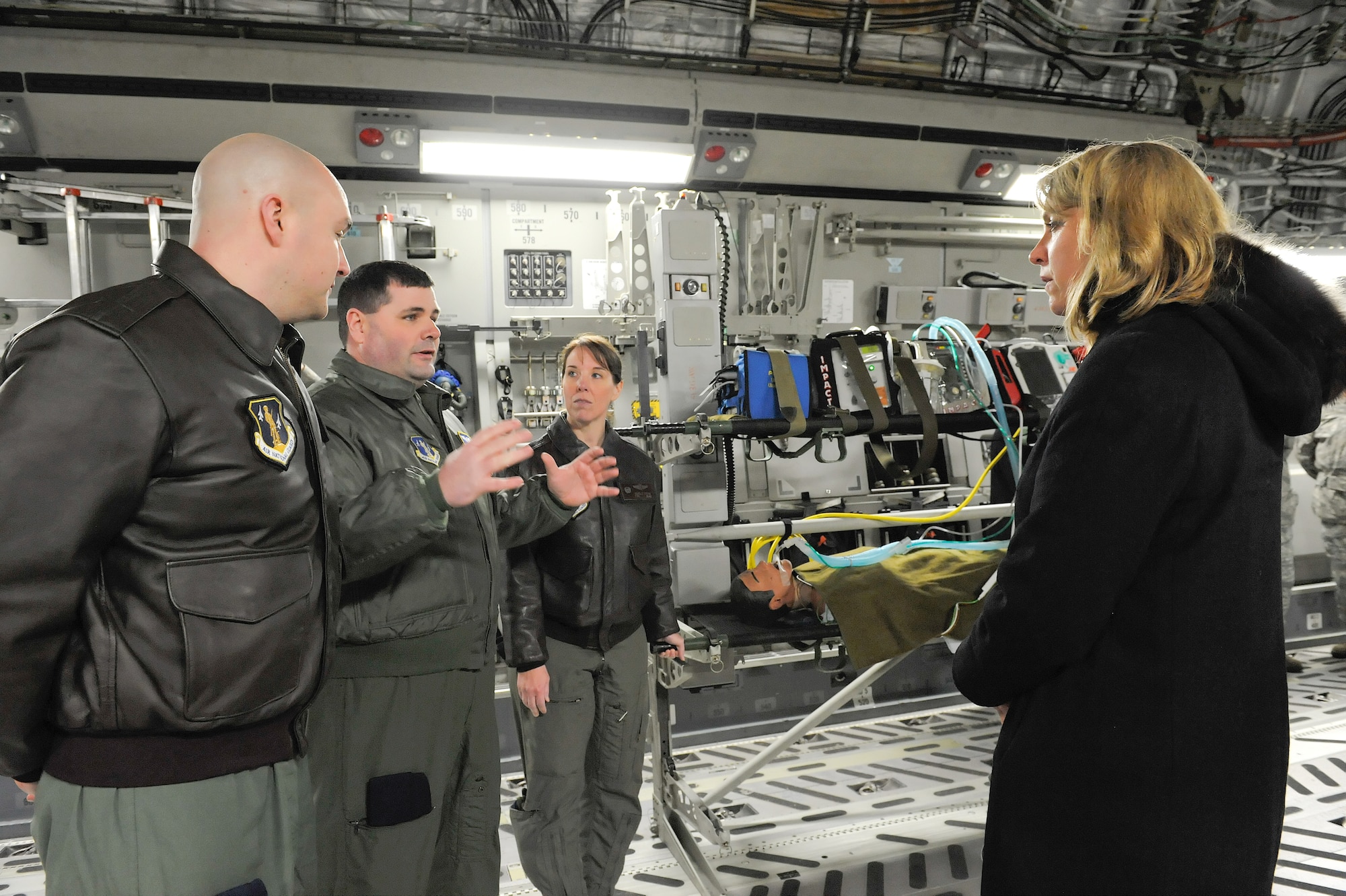 Staff Sgt. Michael McBride, flight instructor, 142nd Aeromedical Evacuation Squadron, 166th Airlift Wing, Delaware Air National Guard (middle left) briefs Secretary of the Air Force Deborah Lee James on the aeromedical evacuation mission inside a C-17A Globemaster III of the 436th Airlift Wing, Jan. 10, 2014, at Dover Air Force Base, Del. As part of the Air Force's total force concept, members of the 142 AES are tasked to provide patient care during transport to advanced care centers. (U.S. Air Force photo/Roland Balik)