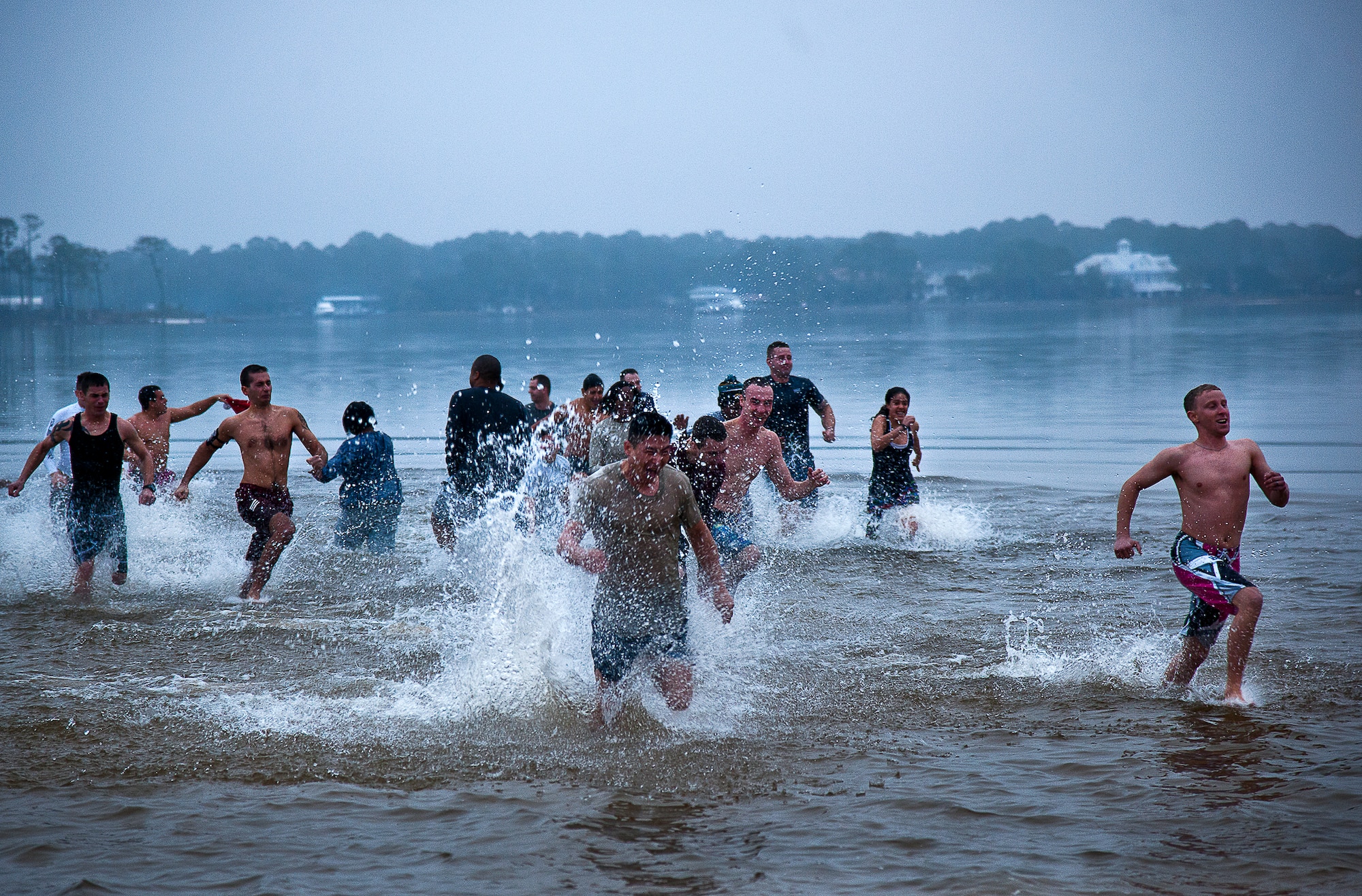 A large group of people exit the chilly waters of Choctawhatchee Bay in a hurry during Eglin’s annual Polar Bear Plunge, held at Post’l Point, Jan. 10.  Only a few brave swimmers lasted longer than five minutes in the 55 degree water.  (U.S. Air Force photo/Samuel King Jr.)