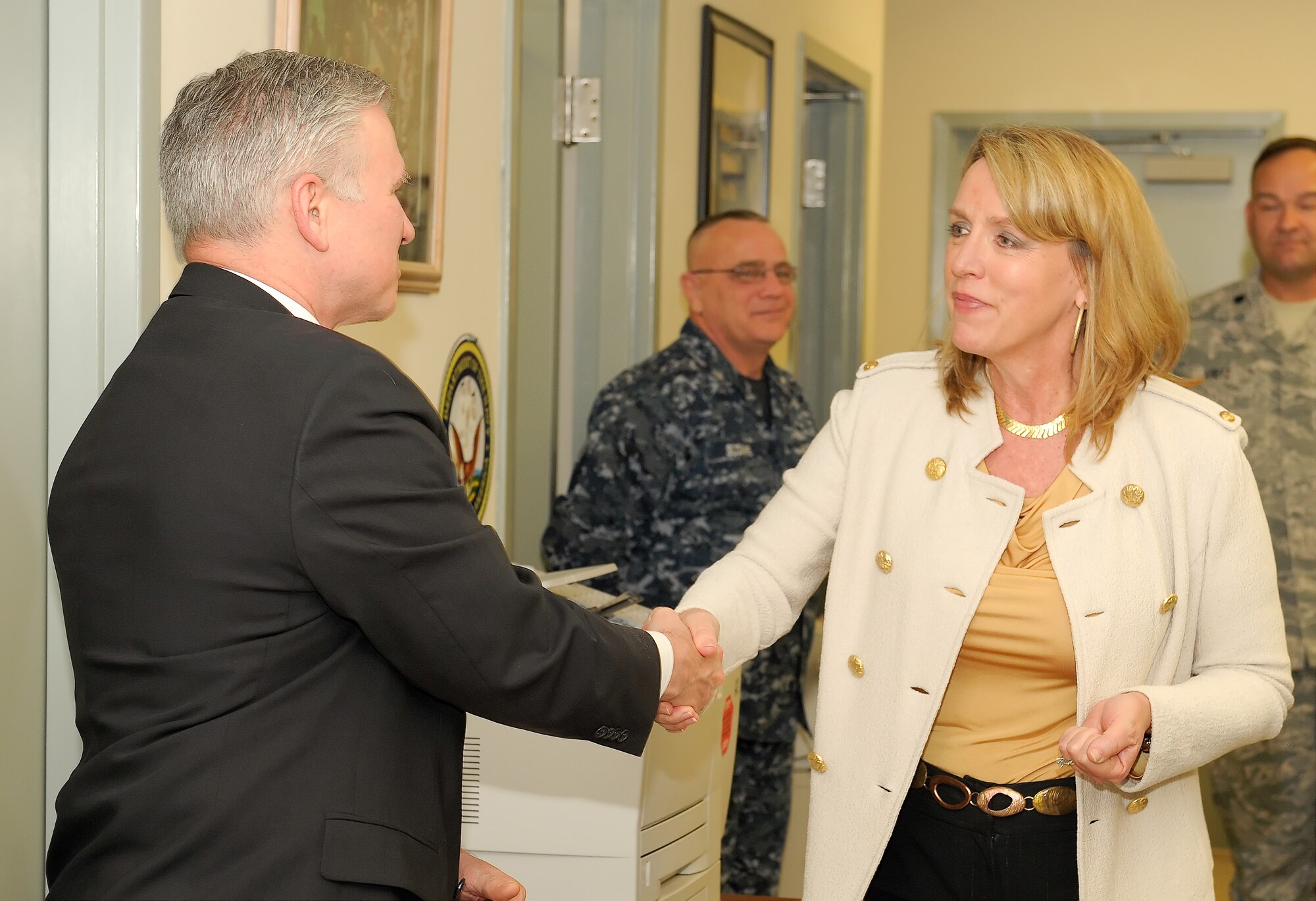 Kevin D. Smith, head of the United States Marine Corps liason team at Air Force Mortuary Affairs Operations greets Secretary of the Air Force Deborah Lee James during a tour of AFMAO during her visit Jan. 10, 2014, at Dover Air Force Base, Del. This is the SecAF's first official visit to an Air Force installation since her confirmation in December 2013. (U.S. 
Air Force photo/Roland Balik)