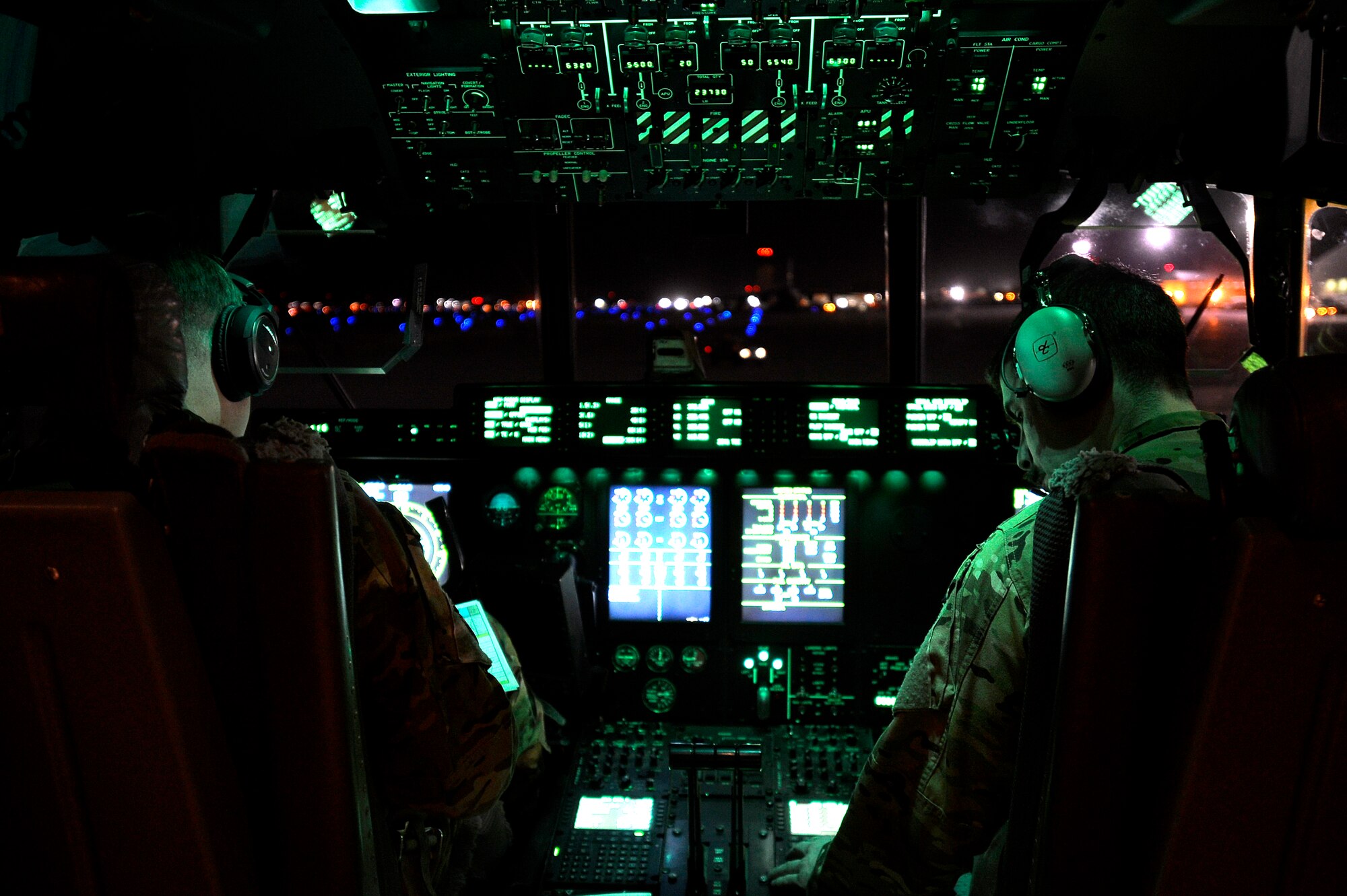Two U.S. Air Force pilots assigned to the 774th Expeditionary Airlift Squadron do preflight checks in a C-130J Super Hercules at Kandahar Airfield, Afghanistan, Jan. 12, 2013. The C-130J Super Hercules, from Dyess Air Force Base, Texas, takes over at Bagram Airfield for the departing C-130 Hercules. (U.S. Air Force photo by Senior Airman Kayla Newman/Released)