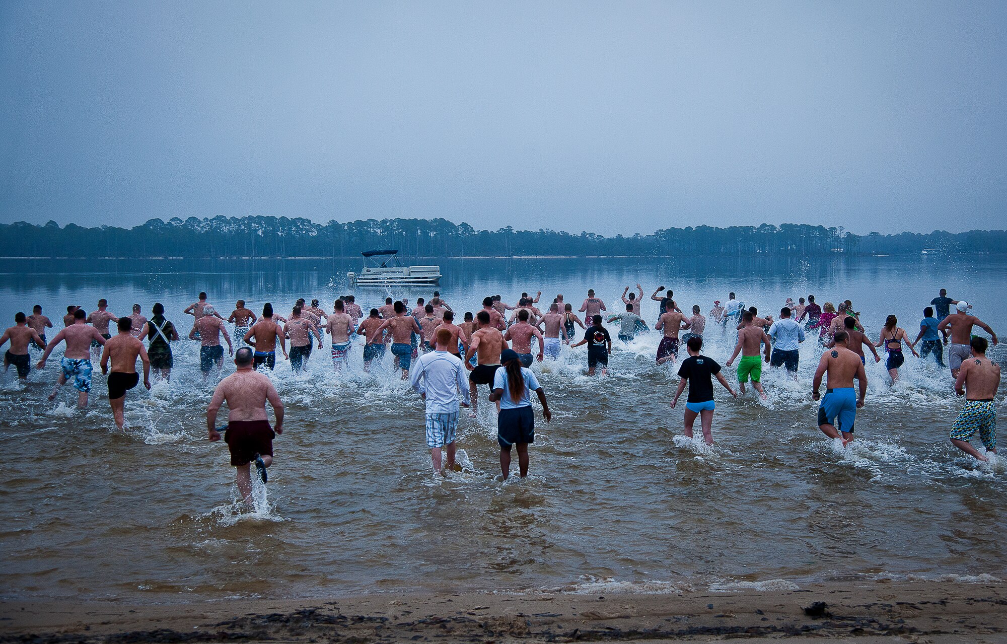 More than 50 people rush into the chilly waters of Choctawhatchee Bay during Eglin’s annual Polar Bear Plunge, held at Post’l Point, Jan. 10.  Only a few brave swimmers lasted longer than five minutes in the 55 degree water.  (U.S. Air Force photo/Samuel King Jr.)