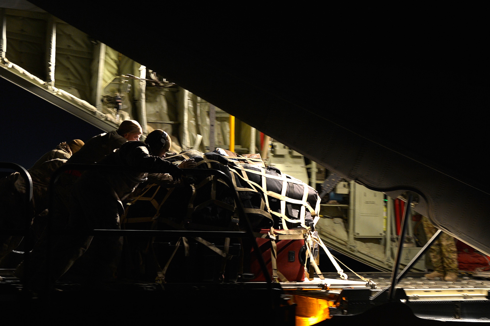 U.S. Air Force Airmen assigned to the 774th Expeditionary Airlift Squadron load cargo into a C-130J Super Hercules at Kandahar Airfield, Afghanistan, Jan. 11, 2013. The C-130J Super Hercules, from Dyess Air Force Base, Texas, takes over at Bagram Airfield for the departing C-130 Hercules. (U.S. Air Force photo by Senior Airman Kayla Newman/Released)