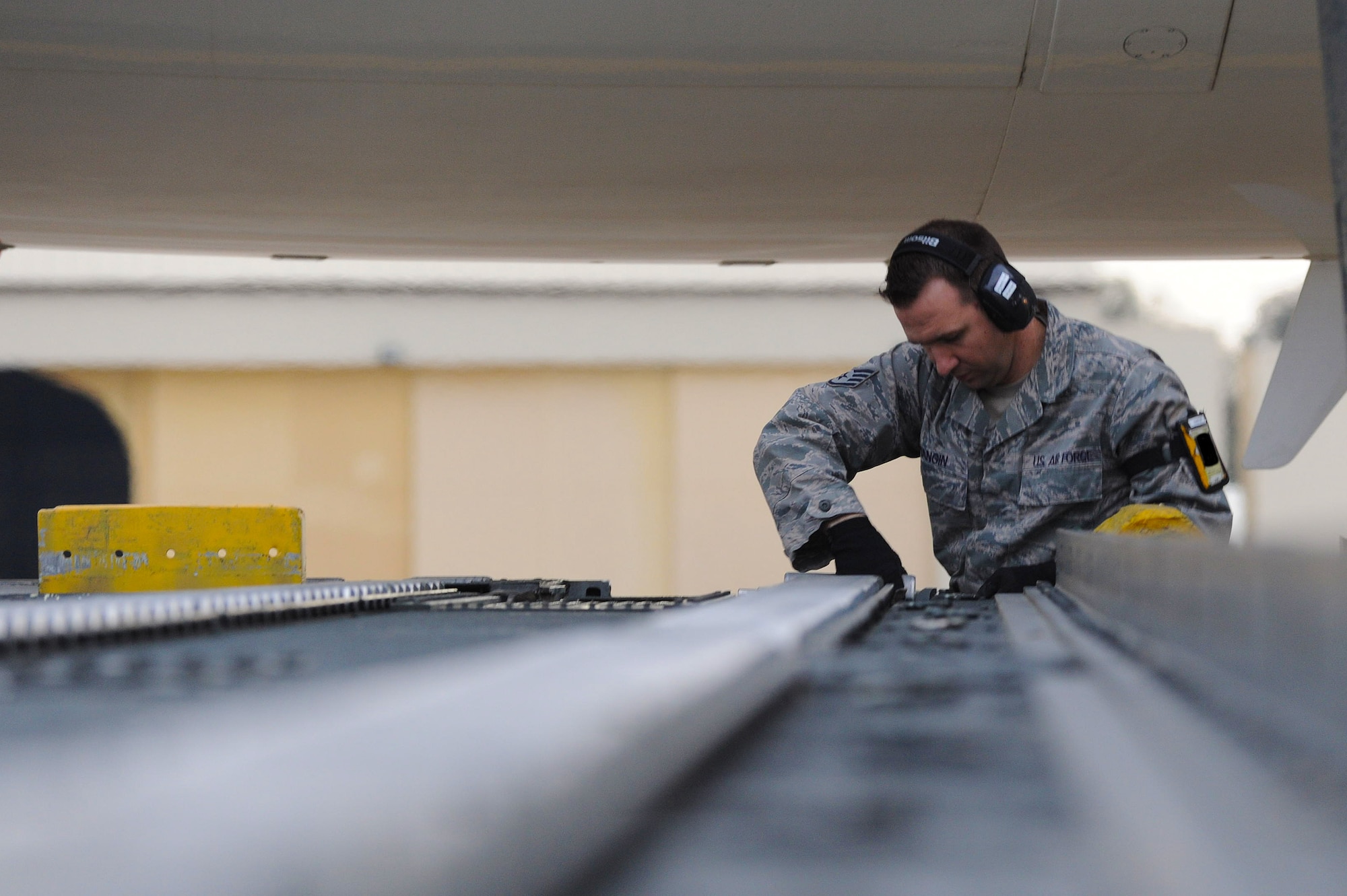 Staff Sgt. William Mangin, 728th Air Mobility Squadron aircraft services load team chief, prepares a 60k loader to download cargo boxes from a French air force Airbus A310 Jan. 9, 2014, at Incirlik Air Base, Turkey. The French air force provided personnel and cargo airlift to the German military as they deployed troops to Turkey where they will assume responsibility for manning two Patriot missile batteries as part of a NATO mission to increase Turkey’s air defense capabilities against Syrian ballistic missile threats. (U.S. Air Force photo illustration by 1st Lt. David Liapis/Released)