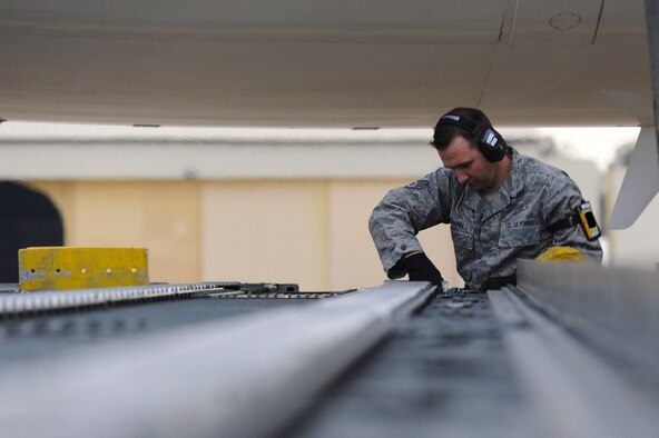 Staff Sgt. William Mangin, 728th Air Mobility Squadron aircraft services load team chief, prepares a 60k loader to download cargo boxes from a French air force Airbus A310 Jan. 9, 2014, at Incirlik Air Base, Turkey. The French air force provided personnel and cargo airlift to the German military as they deployed troops to Turkey where they will assume responsibility for manning two Patriot missile batteries as part of a NATO mission to increase Turkey’s air defense capabilities against Syrian ballistic missile threats. (U.S. Air Force photo illustration by 1st Lt. David Liapis/Released)