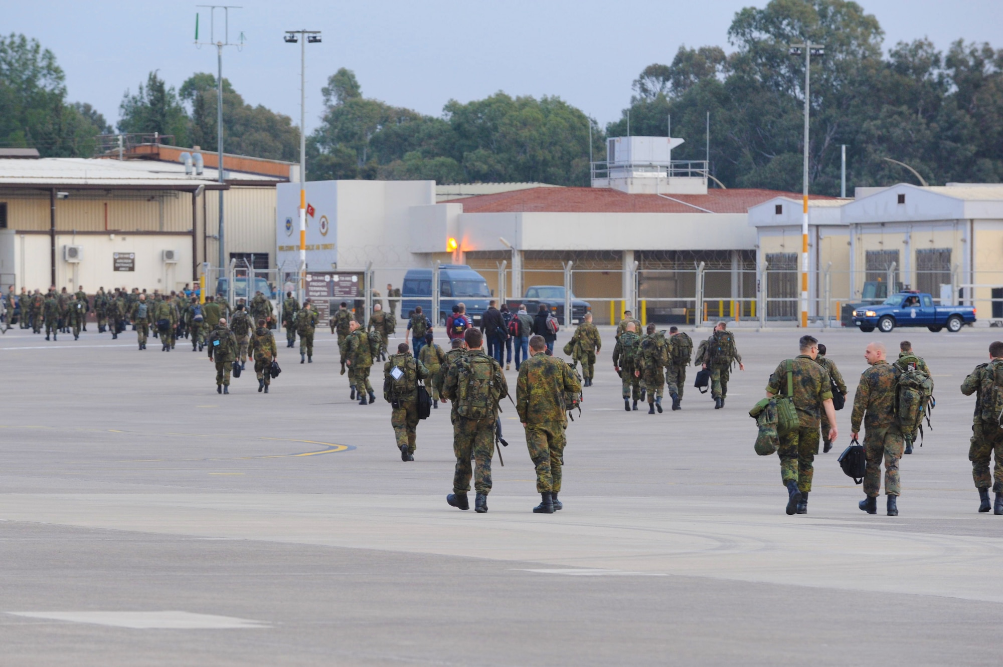 More than 100 German soldiers head toward the passenger terminal at Incirlik Air Base, Turkey Jan. 9, 2014, marking their first steps toward continuing more than a year of German support to the NATO mission to provide Patriot missile coverage for southeastern Turkey against Syrian missile threats. The 728th Air Mobility Squadron provides direct support to the mission by facilitating aircraft and personnel reception as well as cargo downloading. (U.S. Air Force photo by 1st Lt. David Liapis/Released)