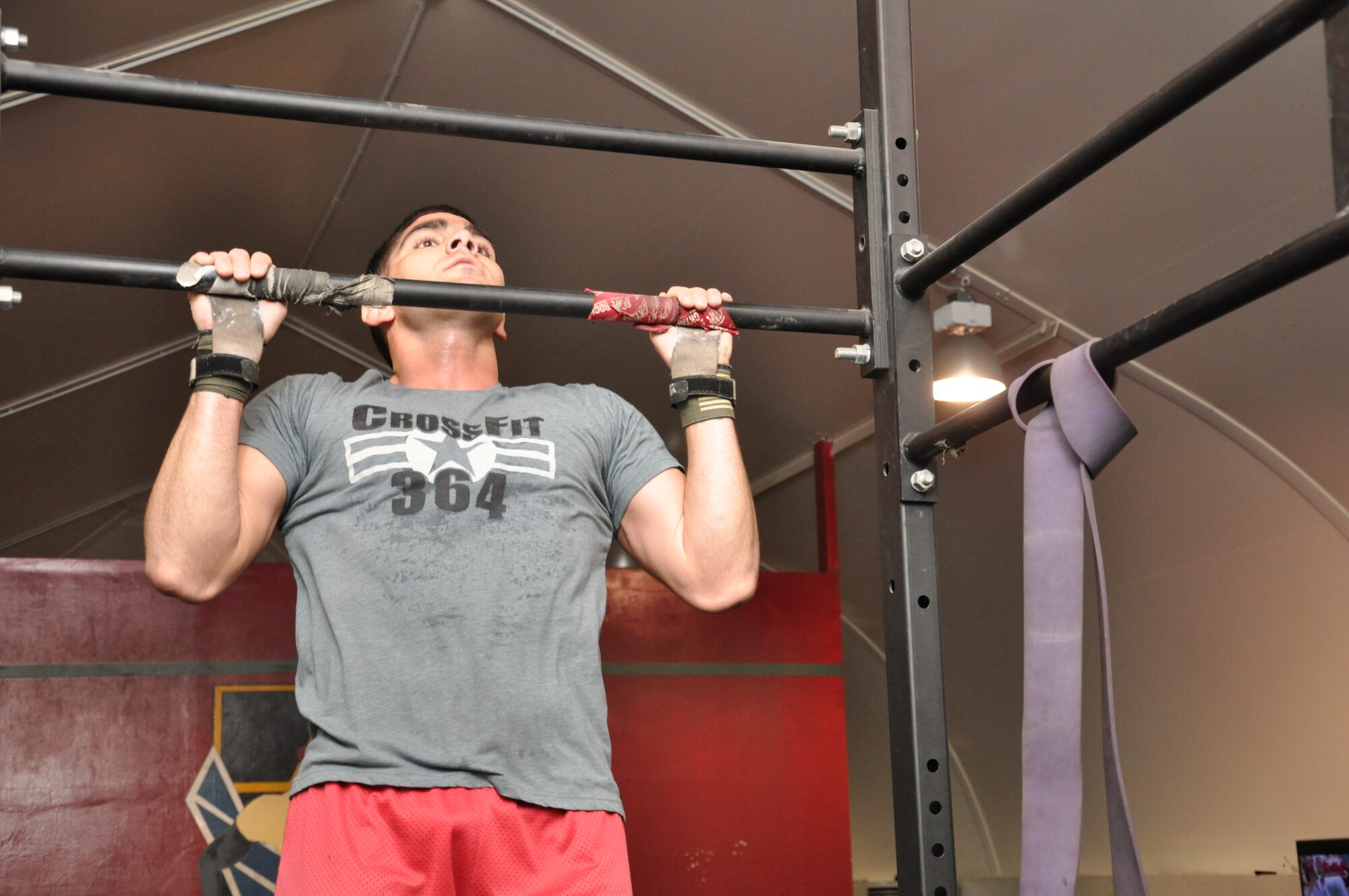 Air Force Capt. Sam Murray, 380th Expeditionary Security Forces Squadron operations officer in charge, does a pull up before a class at the tactical fitness facility at an undisclosed location in Southwest Asia, Jan. 3, 2014. (U.S. Air Force photo by Maj. Khalid Cannon/Released)