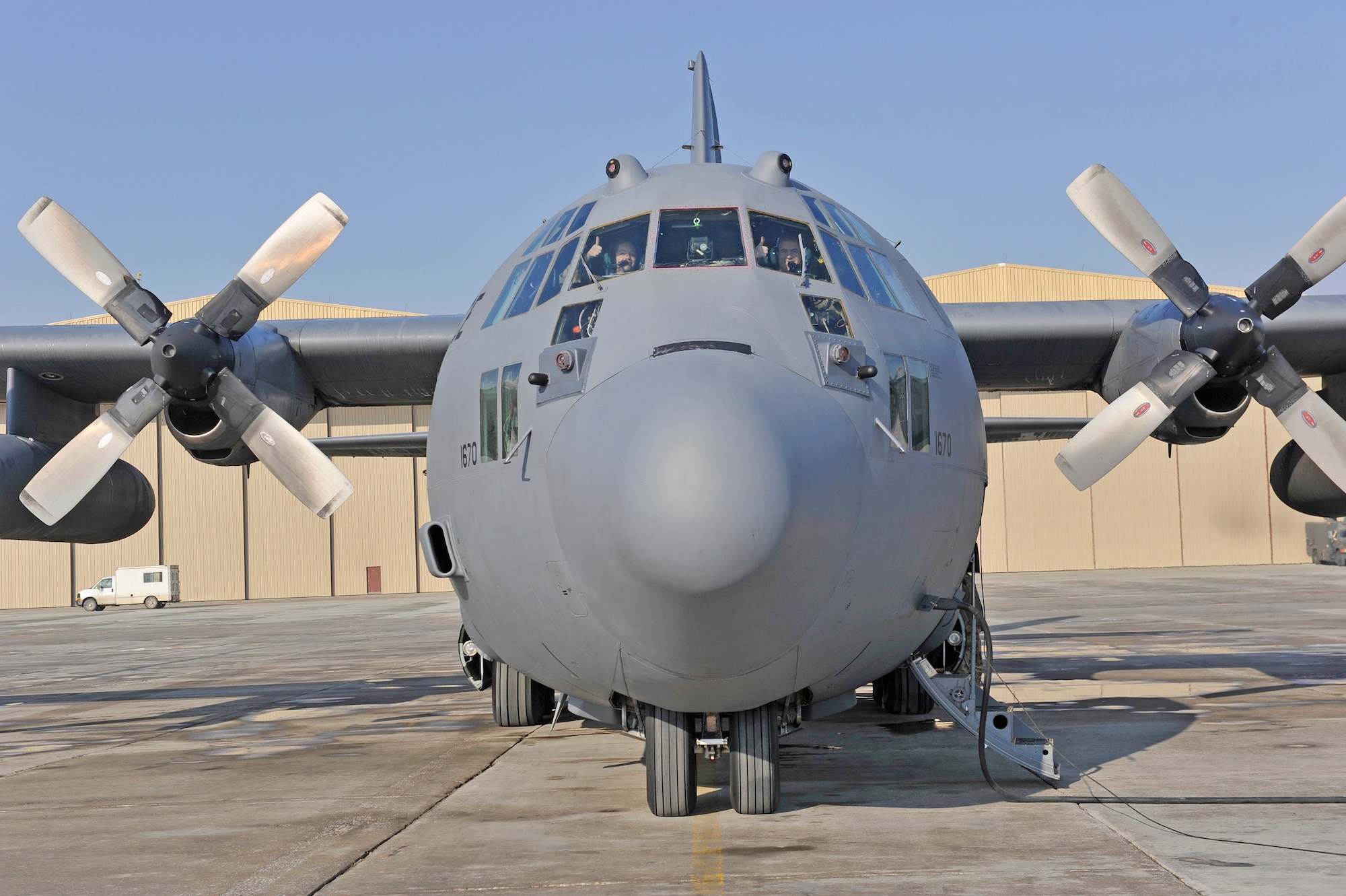 U.S. Air Force Capt. Keri Morris and Maj. Kurt Wampole flash a thumbs-up prior to their departure from Bagram Airfield, Afghanistan, Jan. 9, 2014. They were piloting the first of the C-130H model aircraft to permanently relocate out of Bagram to make room for the newer C-130J model aircraft.(U.S. Air Force photo by Senior Master Sgt. Gary J. Rihn/Released)