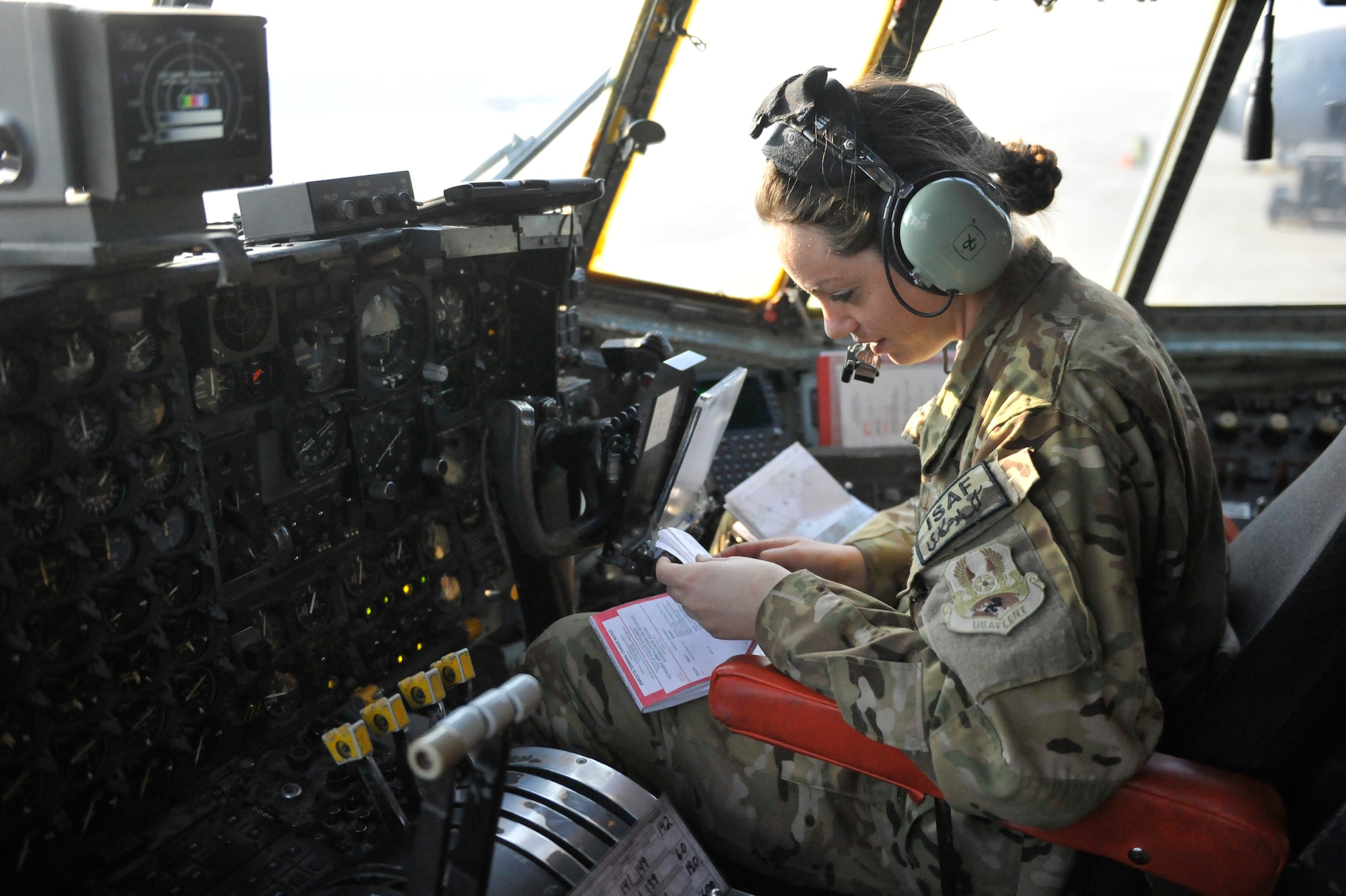 U.S. Air Force Capt. Keri Morris, C-130 co-pilot, consults charts before her flight out of Bagram Airfield, Afghanistan, Jan. 9, 2013. Morris was on the first of the C-130H model aircraft to permanently relocate out of Bagram to make room for the newer C-130J model aircraft.(U.S. Air Force photo by Senior Master Sgt. Gary J. Rihn/Released)