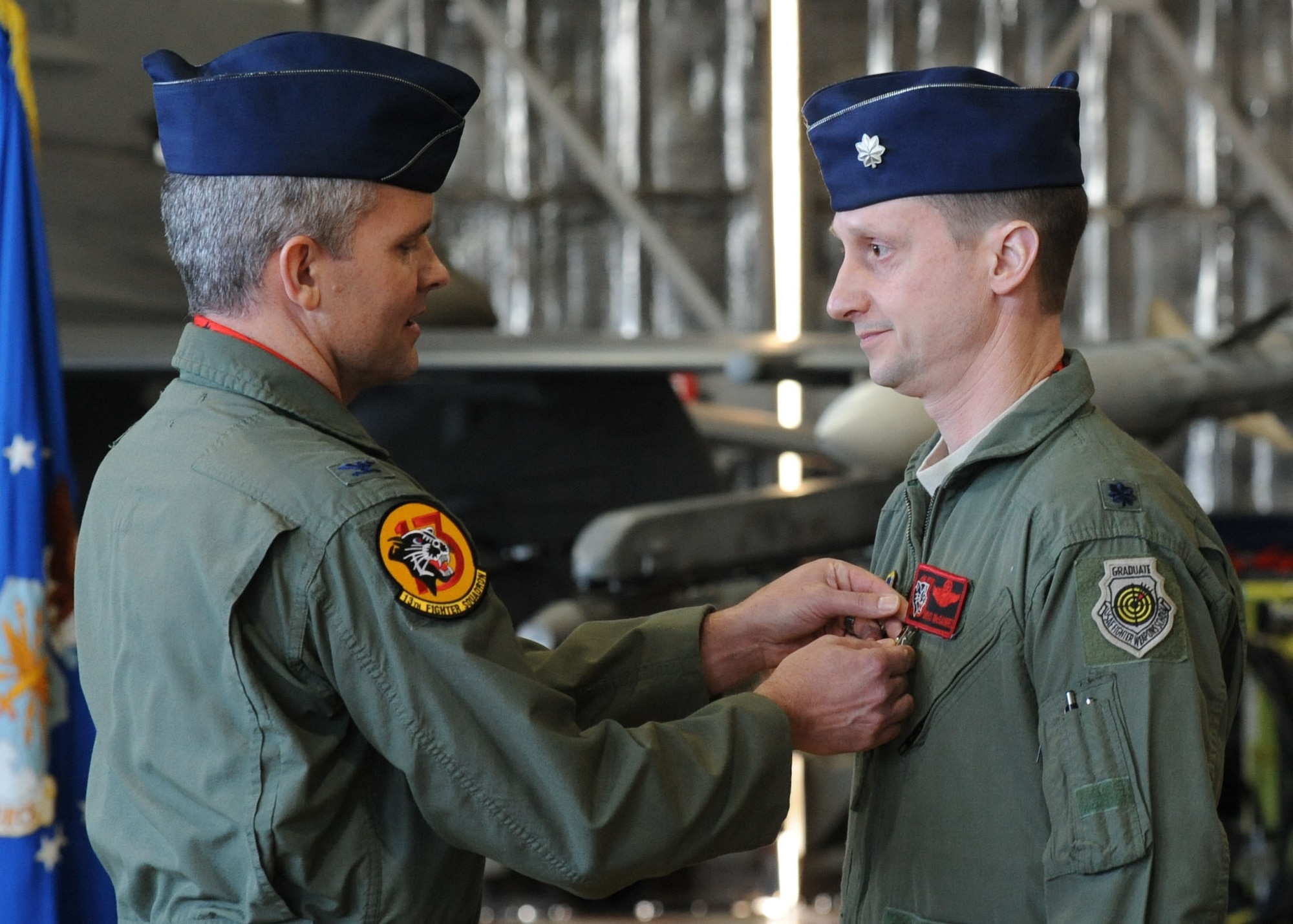 Col. John Parker, 35th Operations Group commander, pins a Meritorious Service Medal on outgoing 13th Fighter Squadron commander Lt. Col. John McDaniel, during the unit’s change of command ceremony Jan. 13, 2014, at Misawa Air Base, Japan. McDaniel was awarded the medal for his contributions to the squadron since assuming command in March 2012. McDaniel is a command pilot with more than 409 combat flight hours. (U.S. Air Force photo/Staff Sgt Alyssa C. Wallace)