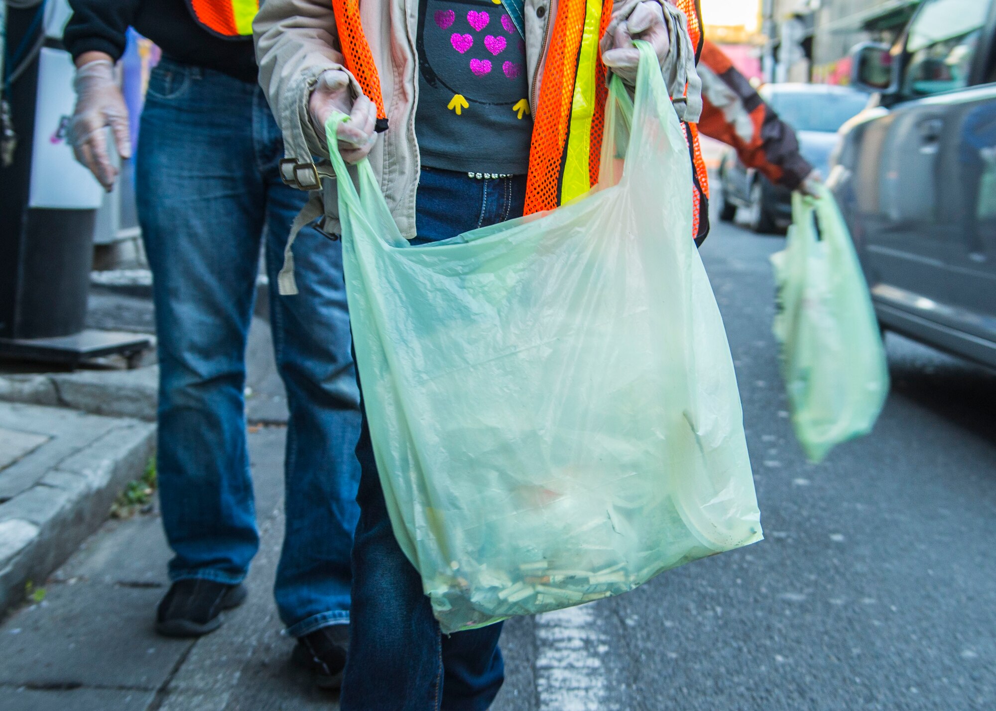 Caitlin Beard, a volunteer worker from Yokota Youth Center seeks out for trash during a community service event honoring the Martin Luther King Jr. Day on Jan. 11, 2014, Fussa City, Japan.  Each group had five volunteers responsible for a specific type of trash to pick up.  (U.S. Air Force photo by Airman 1st Class Soo C. Kim / Released)
