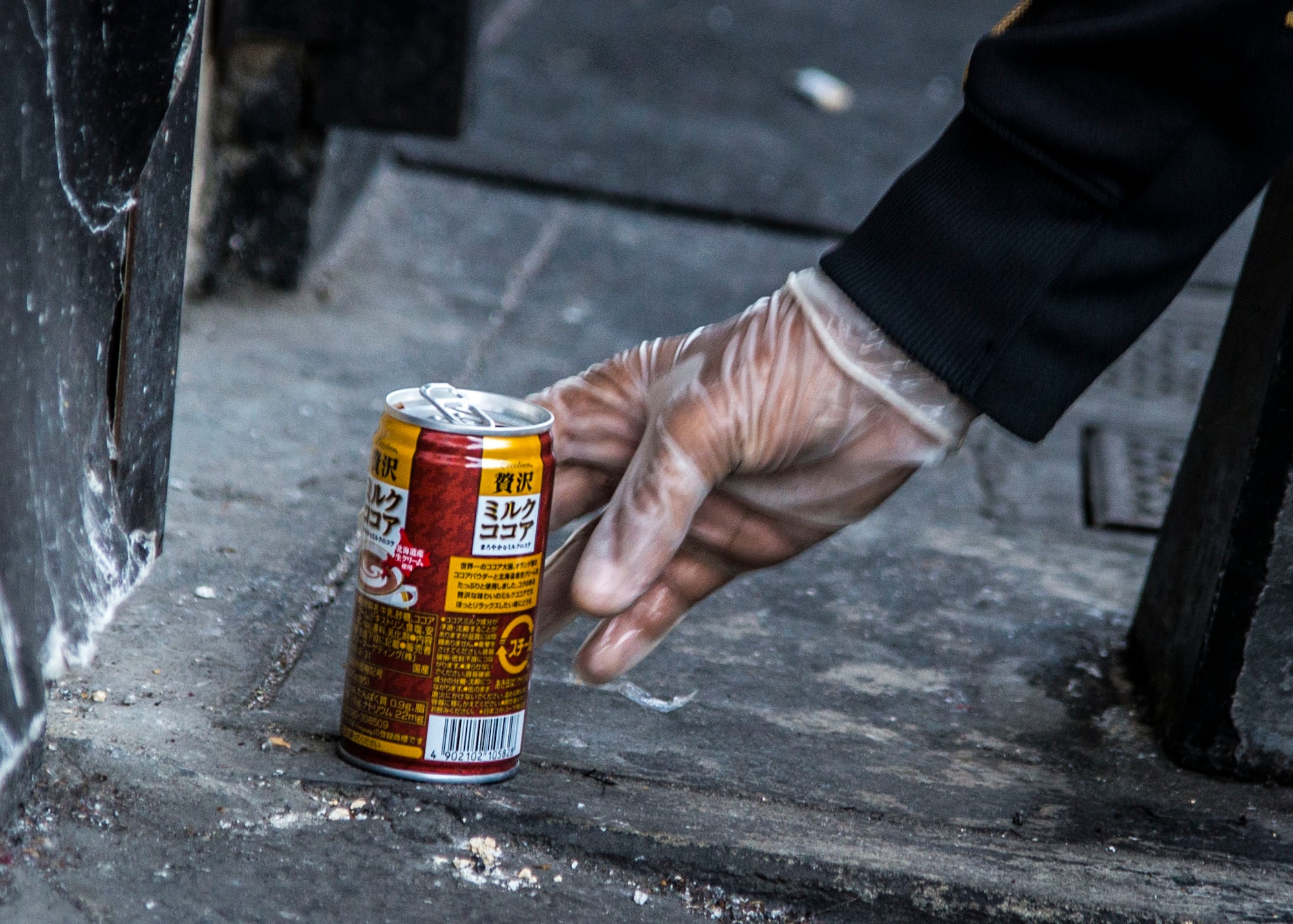 A volunteer worker from Yokota Youth Center reaches for trash during a community service  event honoring Martin Luther King Jr. Day on Jan. 11, 2014, Fussa City, Japan.  The project was to work towards the, “beloved community,” envisioned by Dr. King.  (U.S. Air Force photo by Airman 1st Class Soo C. Kim / Released)