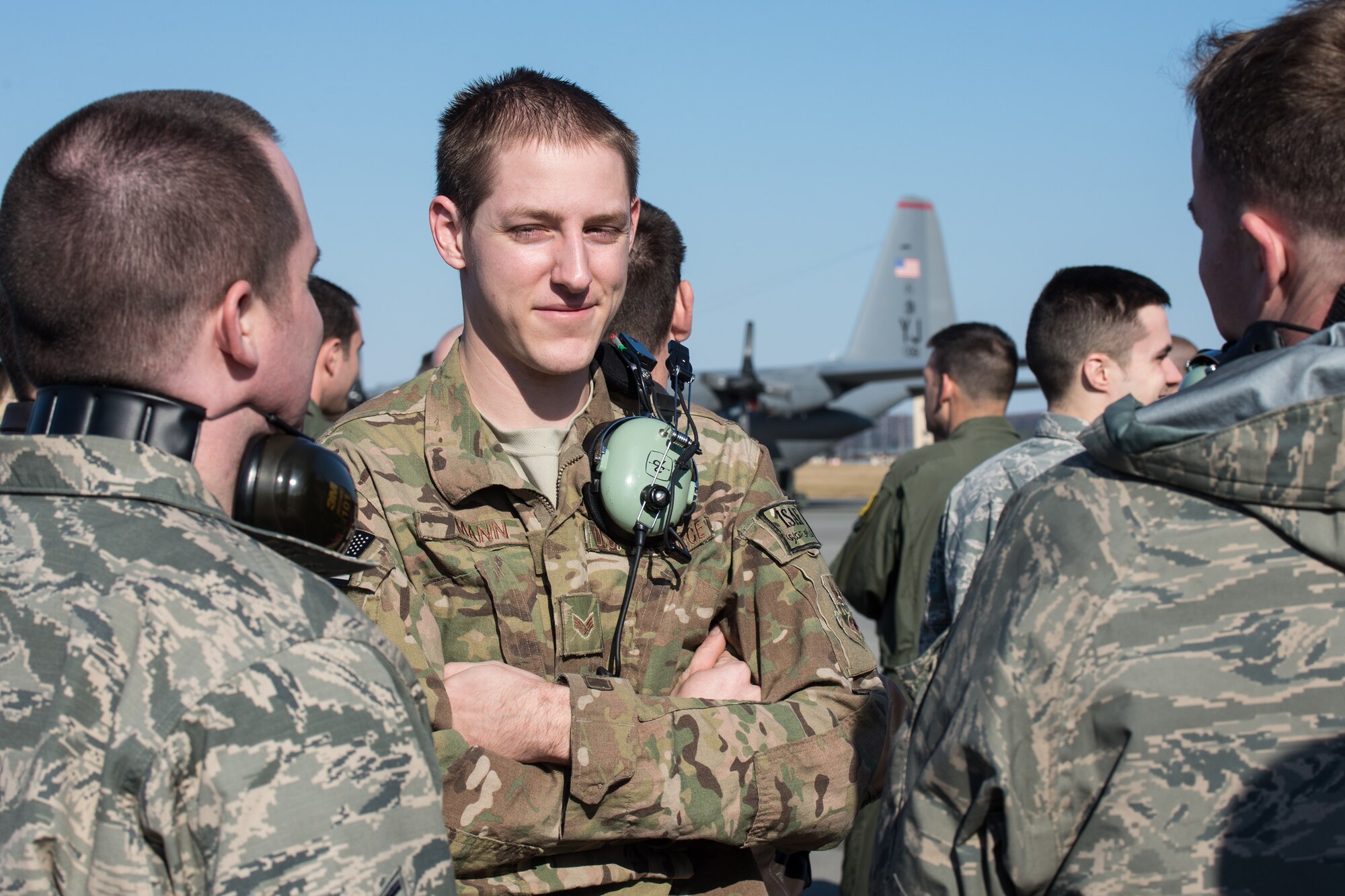 Senior Airman Eric Mann, 374th Aircraft Maintenance squadron, talks with his co-workers after landing at Yokota Air Base, Japan, Jan. 13, 2014.  Mann was one of many Airmen who returned to Yokota following their deployment to Southwest Asia.  (U.S. Air Force photo by Osakabe Yasuo/Released)