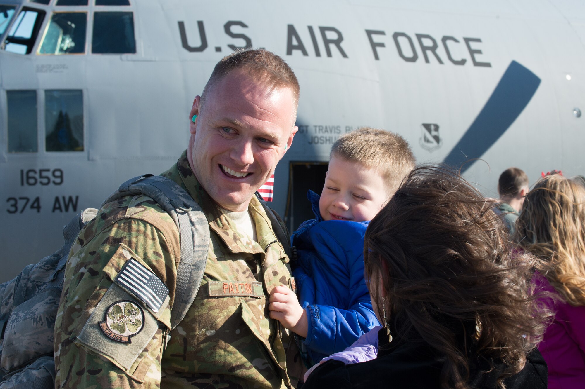 Capt. Christopher Paxton, 36th Airlift Squadron, hold his son, Quincy, at Yokota Air Base, Japan, Jan. 13, 2014. Paxton was one of many Airmen who returned to Yokota following their deployment to Southwest Asia.  (U.S. Air Force photo by Osakabe Yasuo/Released) 