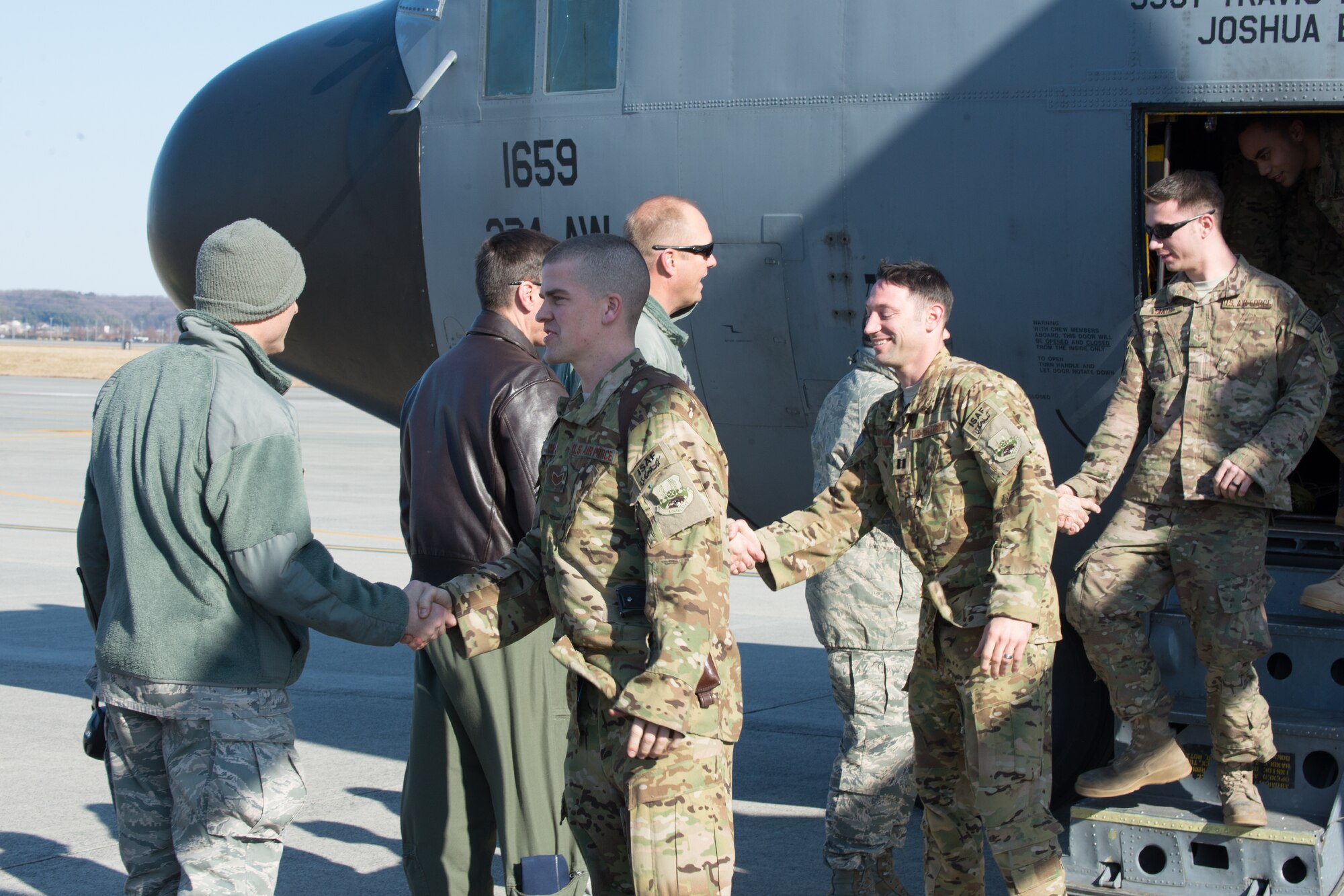 Yokota Air Base leadership shakes hands with returning Airmen Jan. 13, 2014, at Yokota Air Base, Japan.  The Airmen were welcomed home following their deployment to Southwest Asia. (U.S. Air Force photo by Osakabe Yasuo/Released) 