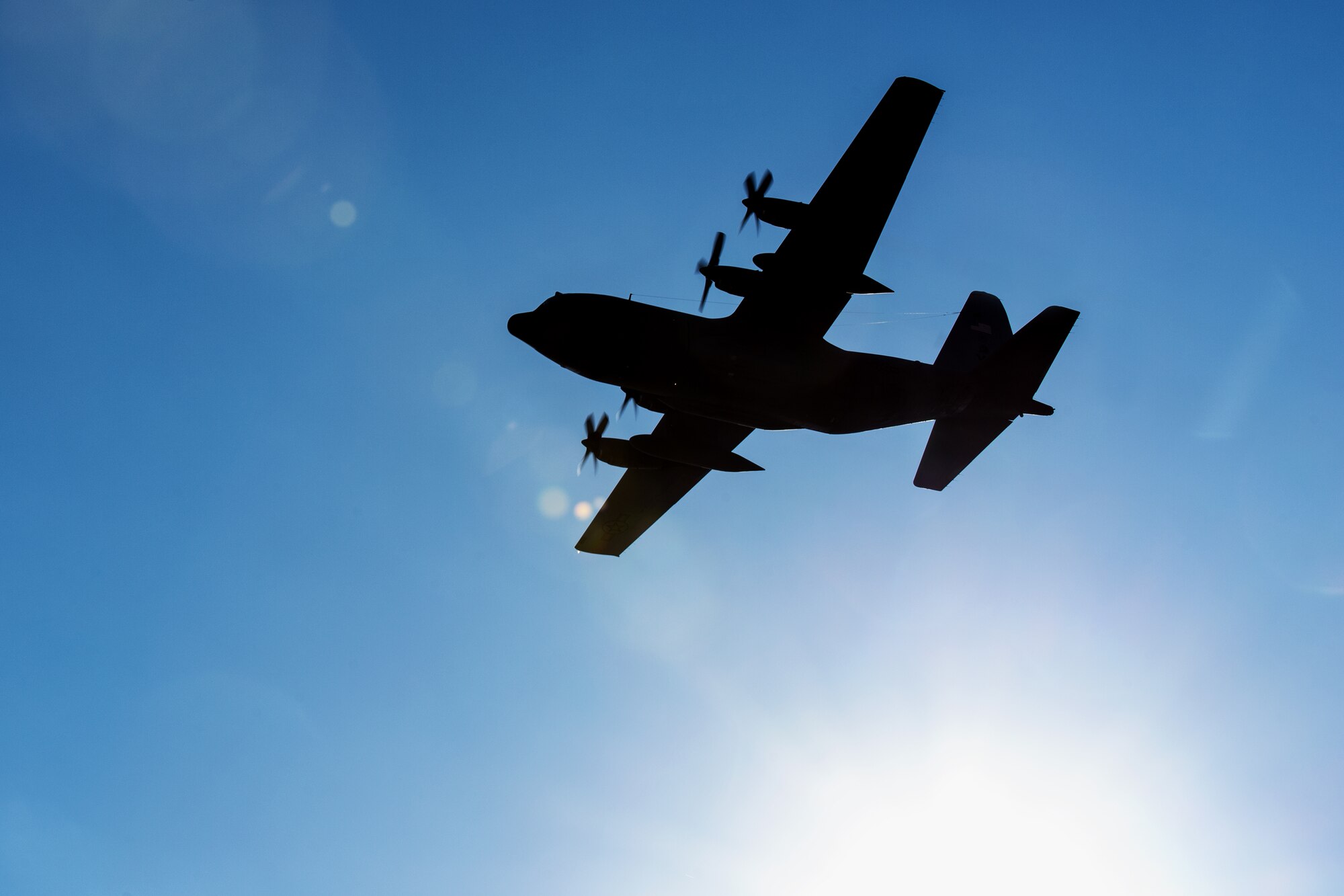A C-130 Hercules flies over Yokota Air Base, Japan, Jan. 13, 2014. The aircraft and the Airmen on board were returning from a deployment to Southwest Asia. (U.S. Air Force photo by Osakabe Yasuo/Released)