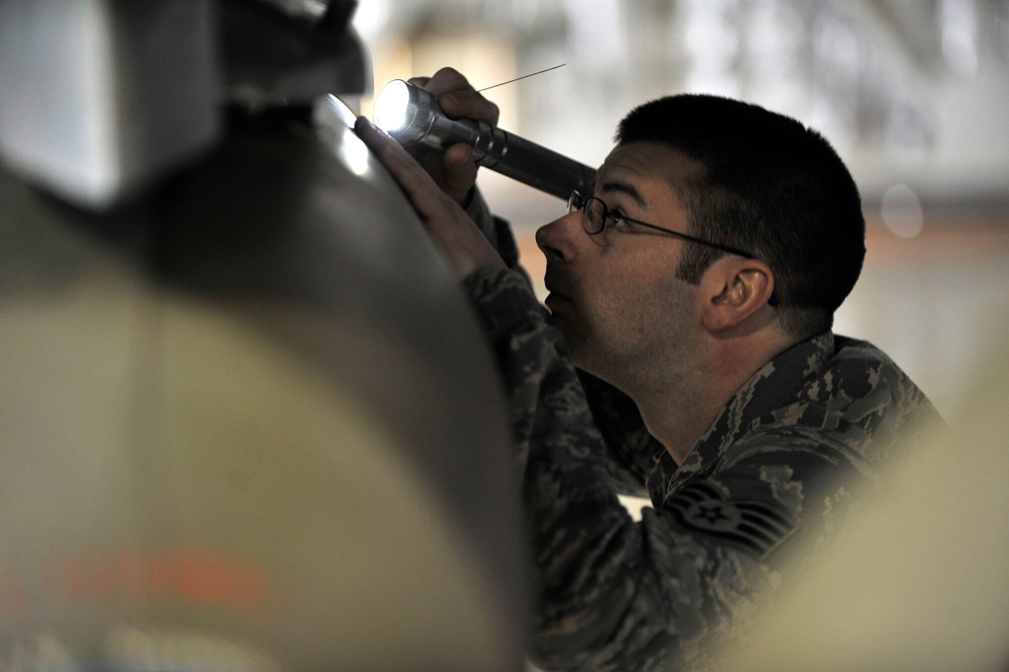 MISAWA AIR BASE, Japan – Staff Sgt. Robert Boerner, 35th Maintenance Group load crew member, inspects the quality of an F-16 Fighting Falcon bomb load for the 4th Quarter Load Crew Competition at Misawa Air Base, Japan, Jan. 10, 2014. The 13th Aircraft Maintenance Unit load crew team includes Staff Sgt. Derek Pascoe, crew chief lead, Senior Airman Daniel Moreno, two-man, and Senior Airman Michael Martinez, three-man who beat out their opponent to claim the best load team for the fourth quarter, October to December 2013. (U.S. Air Force Photo by Staff Sgt. Tong Duong)