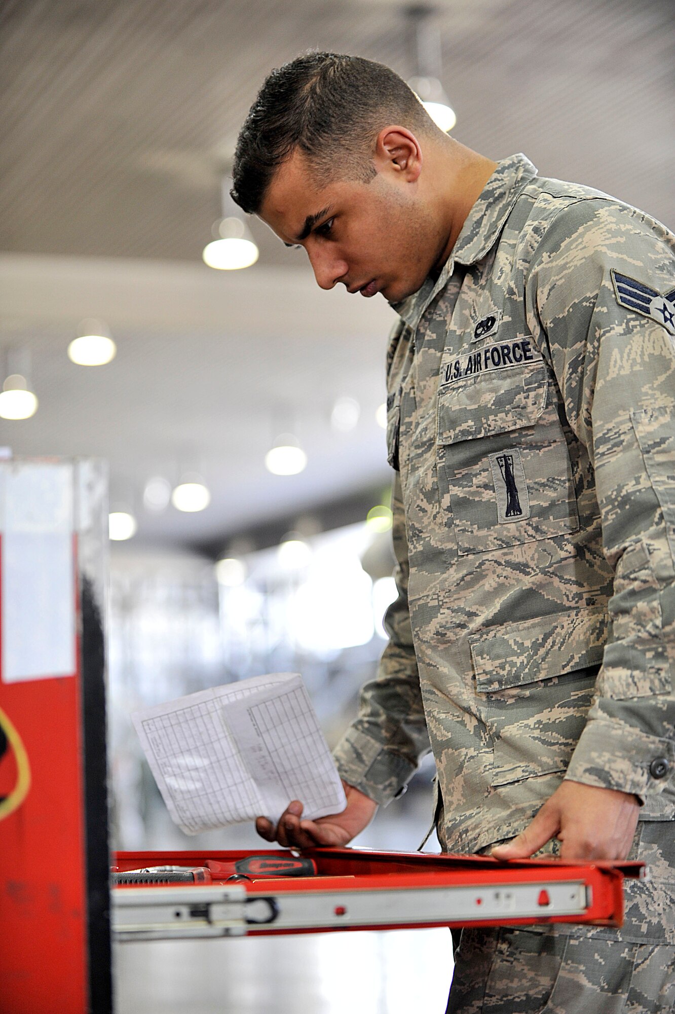 MISAWA AIR BASE, Japan – Senior Airman Khalil Bashir, 35th Maintenance Operations Squadron load crew member, inspects a composite tool kit for the 4th Quarter Load Crew Competition at Misawa Air Base, Japan, Jan. 10, 2014. Inspectors like Bashir ensure weapons are loaded safely and check crew chiefs for technical proficiency and reliabilities. (U.S. Air Force Photo by Staff Sgt. Tong Duong)