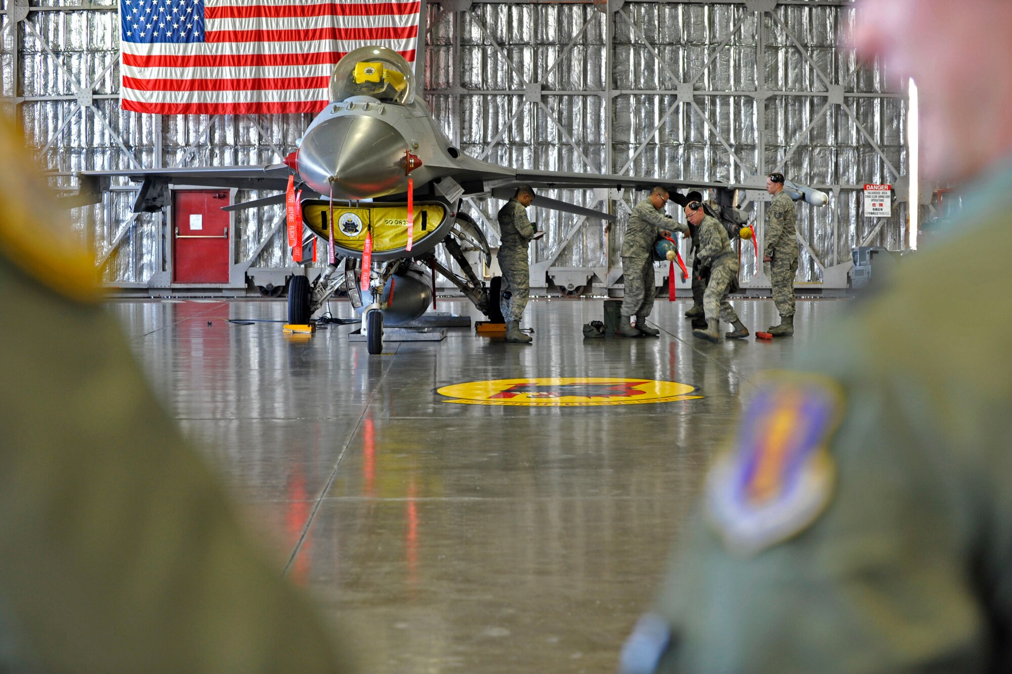 MISAWA AIR BASE, Japan – Spectators watch as squadron lead crew members evaluate the safety and reliability of 13th Aircraft Maintenance Unit members for the 4th Quarter Load Crew Competition at Misawa Air Base, Japan, Jan. 10, 2014. The load crew is comprised of a team chief, a two-man, and a three-man. (U.S. Air Force Photo by Staff Sgt. Tong Duong)