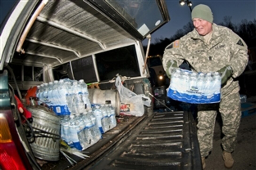 Army Command Sgt. Maj. Steve Deweese loads water into a vehicle at the courthouse in Winfield, W.Va., Jan. 11, 2014. Authorities told residents of Kanawha, Boone, Putnam, Lincoln, Logan, Clay, Roane and Jackson counties to stop using tap water after a chemical leak contaminated the West Virginia American Water company’s system in those areas. Deweese is assigned to the training center on Camp Dawson in Kingwood, W.Va.