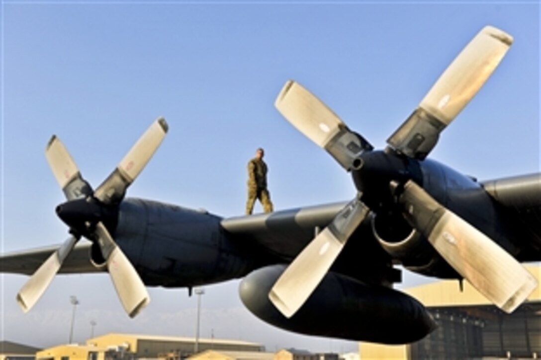 U.S. Air Force Staff Sgt. David Billings inspects his aircraft's wings before his flight out of Bagram Airfield, Afghanistan, Jan. 9, 2014. Billings was on the first of the C-130H aircraft to permanently relocate out of Bagram to make room for the newer C-130J models. Billings is a C-130 flight engineer.