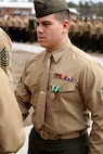 Cpl. Brian E. Babineau, a Gardner, Mass., native and a warehouse clerk with Supply Company, 2nd Supply Battalion, 2nd Marine Logistics Group, shakes hands with Lt. Col. Jesse A. Kemp, the commanding officer of Supply Battalion, after receiving the Navy Commendation Medal for saving a young girl’s life at North Topsail Beach, N.C., July 14, 2013 at an award ceremony at the French Creek barracks aboard Camp Lejeune, N.C., January 10, 2014. Babineau swam out into the ocean and brought back the young girl who was being drifted away by a rip current. 