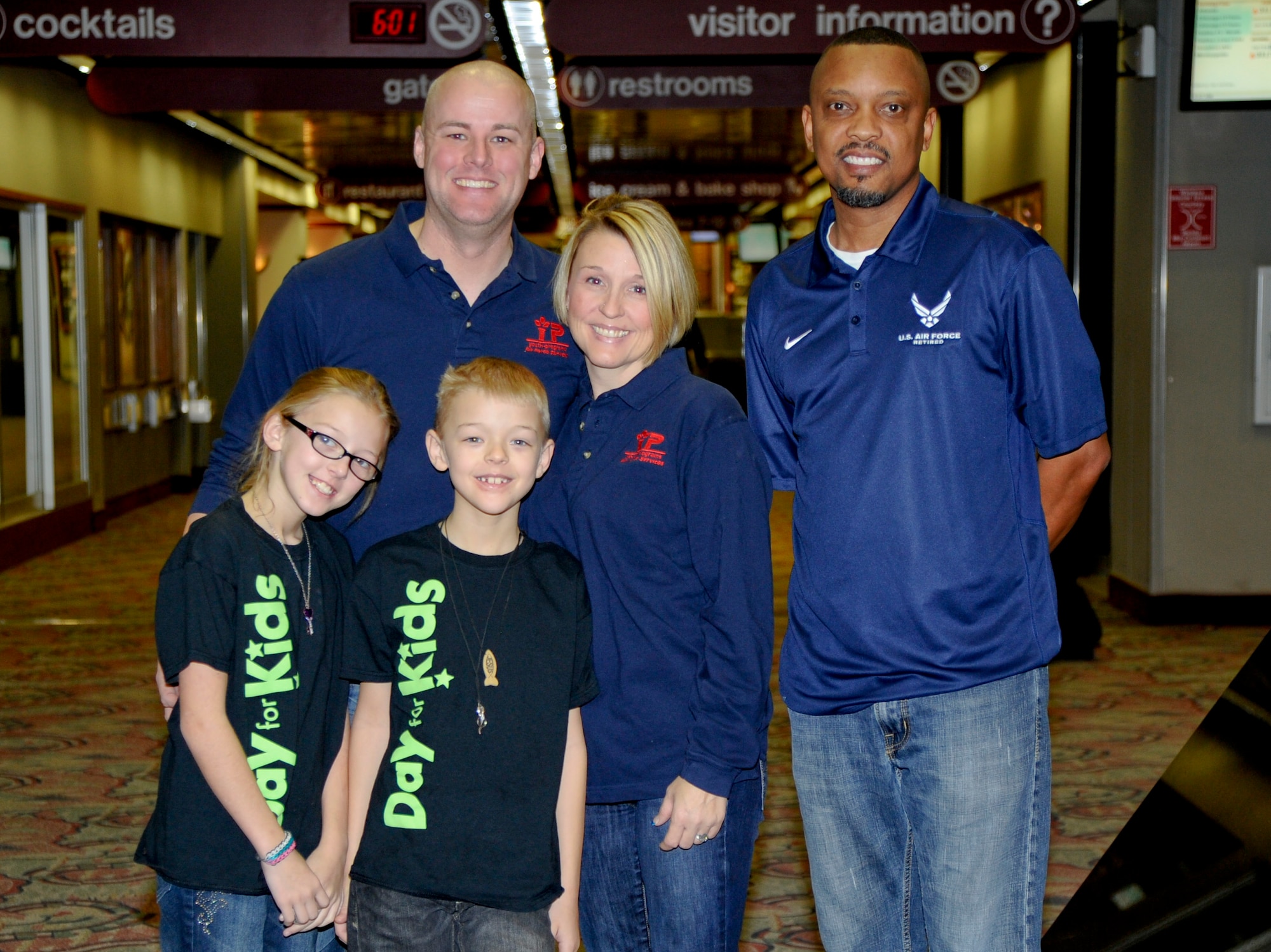 1st Lt. Scott Blair, 22nd Medical Group resource flight commander, his wife Heather, children Paige Alise and Braxton, and James Jolliff (left), 22nd Force Support Squadron Youth Center director, pose for a picture Jan. 10, 2014 at the Wichita Mid-Continent Airport, Kan. The Blairs are traveling to Los Angeles to compete with four other families in the Triple Play Fit Family Challenge, a health-promoting competition they were introduced to by Jolliff. (U.S. Air Force photo/Airman 1st Class John Linzmeier)