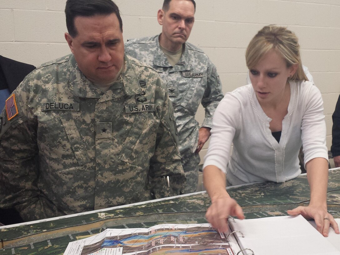 U.S. Army Corps of Engineers Mississippi Valley Division Commander Brig. Gen. Duke DeLuca, St. Louis District Commander Col. Chris Hall and Ashley Cox, St. Louis District river engineer discuss the advancements that have been made in river engineering with the use of Hydrologic Sediment Response Models at the St. Louis District's Applied River Engineering Center, Jan. 14. (Photo by USACE St. Louis District Public Affairs Office)