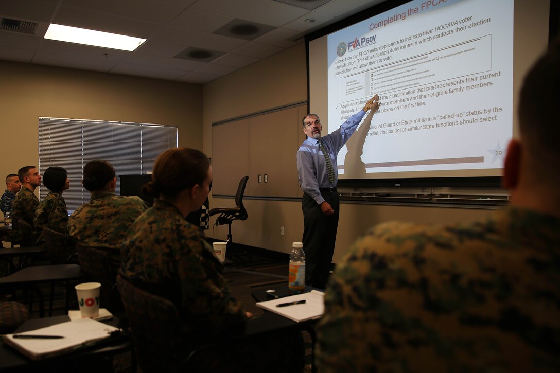 Paddy McGuire, the deputy director for the Federal Voting Assistance Program, conducting Voting Assistance Officer Training at the military post office, Jan. 14.
McGuire provided information to voting assistance officers about how to help people in their military units interested in voter registration and participating in the electoral process.
“We know that there is a lot of turnover among voting assistance officers, so we want them to be familiar with the forms, rules, and where to find information to help people interested in participating in the process to vote,” said McGuire.
