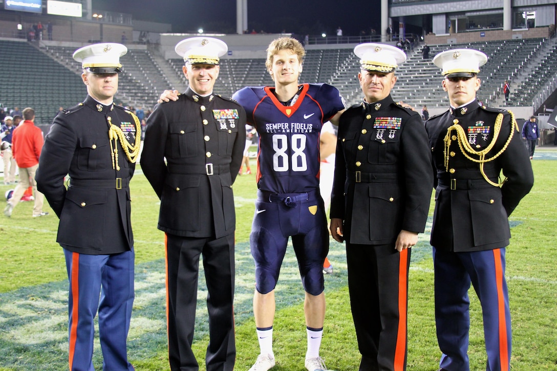 CARSON, CA— Tyler Newsome, a punter and kicker for the Semper Fidelis All-American Bowl East team, poses with Marines at the conclusion of the Semper Fidelis All-American Bowl at The StubHub Center in Carson, Calif., Jan. 5. Newsome, a native of Carrollton, GA, is committed to the University of Notre Dame. The Semper Fidelis All-American Bowl is unique because the players are among the most talented players in the nation and are high-academic performers and leaders in their communities. The Semper Fidelis All-American Bowl works to build effective leaders and quality citizens by instilling Marine Corps values. The Semper Fidelis All-American Bowl brings selected players together with U.S. Marines and football coaches to develop skills not only important to football, but throughout life, such as leadership, self-confidence and teamwork. (U.S. Marines Corps photo by Cpl. Courtney G. White/released)