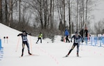 Spc. Jake Todd, left, Alaska Army National Guard and Staff Sgt. Jamie Haines, right, Alaska Air National Guard, sprint to the finish line during the pursuit competition of the National Guard Bureau's Western Regional Biathlon at Kincaid Park in Anchorage, Alaska, Jan. 12, 2014.