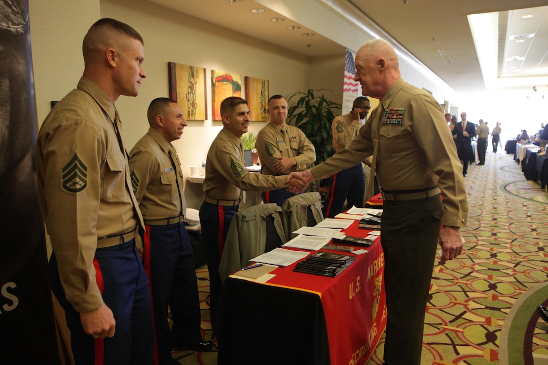Prior-service recruiters shake hands with Lt. Gen. Richard P. Mills, the commander of Marine Forces Reserve and Marine Forces North, during the annual IRR Mega-Muster in Fort Worth, Texas, Jan. 11, 2014. Prior-Service Recruiters were there to talk with Marines about opportunites they have and benefits of re-enlisting. The annual mega-muster is sponsored by the Marine Corps Individual Reserve Support Activity, Marine Forces Reserve. The muster gives IRR Marines an opportunity to update personal information, get information on education and job opportunites, and go through medical screening. (Official photo by Lance Cpl. Brytani Musick)