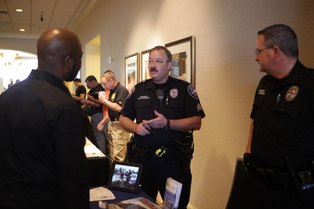 Sherman Police Department officers talk with Individual Ready Reserve Marine Kevin Ogden about job opportunities and retirement benefits during the annual IRR Mega-Muster in Fort Worth, Texas, Jan. 11, 2014. The annual mega-muster is sponsored by the Marine Corps Individual Reserve Support Activity, Marine Forces Reserve. The muster gives IRR Marines an opportunity to update personal information, get information on education and job opportunites, and go through medical screening.(Official photo by Lance Cpl. Brytani Musick)