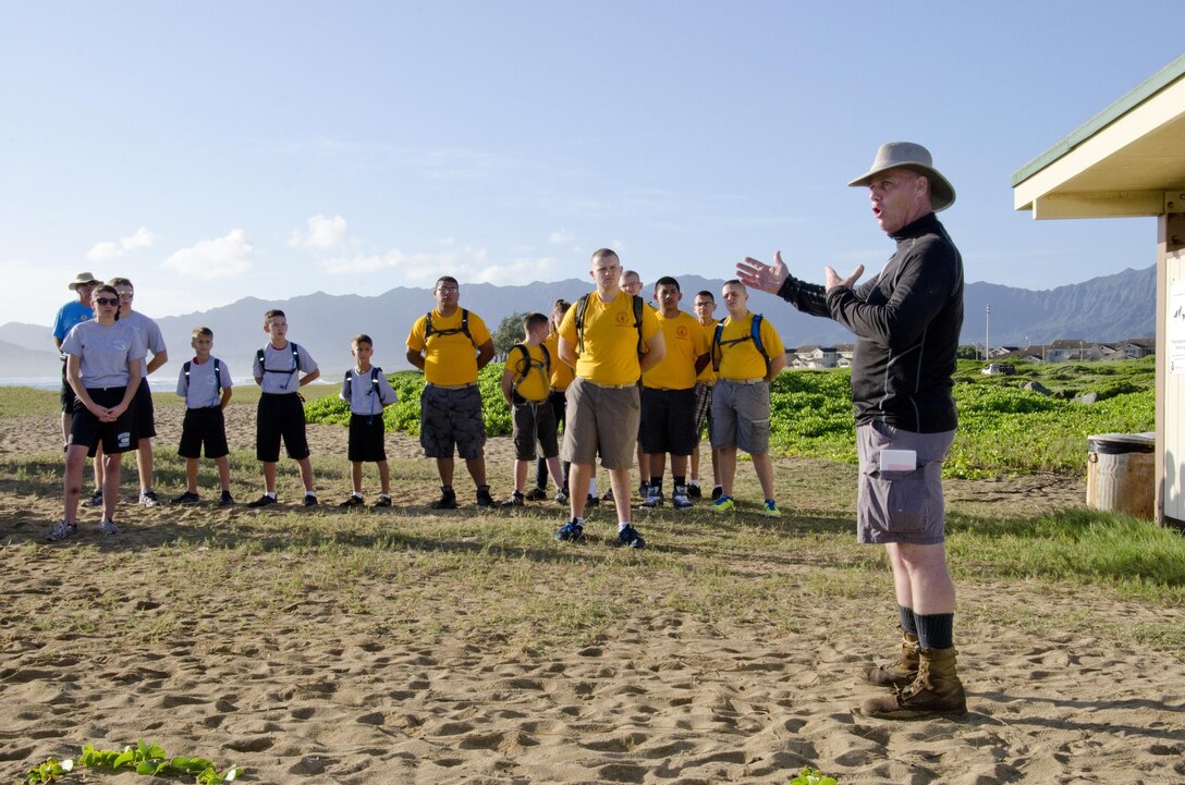 Lance Bookless, the senior natural resources manager at the Environmental Compliance and Protection Department, gives a brief to the Young Marines and Marines from Headquarters Battalion and Marine Corps Air Station Kaneohe Bay before they clean Fort Hase Beach, Dec. 4, 2013. More than 20 Young Marines from units in Florida, Kentucky and Washington joined the Pyramid Rock Young Marines and active-duty Marines to clean the beach. Young Marine units annually travel to Hawaii to commemorate the anniversary of the Dec. 7 attacks by participating in a parade and wreath laying. This year they also participated in the basewide clean-up, Malama Ka Aina. Young Marine Sgt. Maj. Dakota Richter, the National Young Marine of the Year, from Florence, Ky., said the beach clean-up was the best form of community service and the group is grateful for the base’s hospitality. Young Marine Sgt. Maj. Storme DiGiovanni, 17, of Kailua, said the clean-up was a great opportunity for the Young Marines to come together for an activity, especially helping preserve the nature of Hawaii’s beaches. (U.S. Marine Corps photo by Kristen Wong)