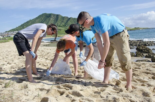 Young Marines collect trash at Fort Hase Beach, Dec. 4, 2013. More than 20 Young Marines from units in Florida, Kentucky and Washington joined the Pyramid Rock Young Marines and active-duty Marines to clean the beach. Young Marine units annually travel to Hawaii to commemorate the anniversary of the Dec. 7 attacks by participating in a parade and wreath laying. This year they also participated in the basewide clean-up, Malama Ka Aina. Young Marine Sgt. Maj. Dakota Richter, the National Young Marine of the Year, from Florence, Ky., said the beach clean-up was the best form of community service and the group is grateful for the base’s hospitality. Young Marine Sgt. Maj. Storme DiGiovanni, 17, of Kailua, said the clean-up was a great opportunity for the Young Marines to come together for an activity, especially helping preserve the nature of Hawaii’s beaches. (U.S. Marine Corps photo by Kristen Wong)