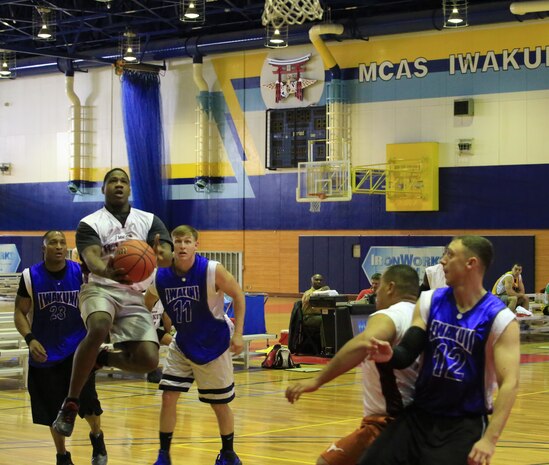 Sgt. Gilliam L. Tyaquan, assistant supply chief with Marine Aircraft Group 12, goes for a layup during the Commander’s Cup 3 vs. 3 Basketball Tournament inside the IronWorks Gym aboard Marine Corps Air Station Iwakuni, Japan, Jan. 10, 2014. The tournament was the first competition for Commander’s Cup in 2014.