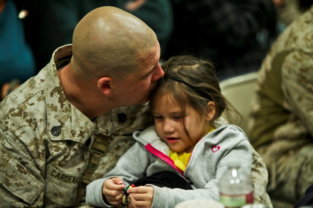 Staff Sgt. Jesus Cardenas, motor transport chief with 1st Combat Logistic Regiment, from Nogales, Ariz., spends time with his daughter moments before departing Camp Pendleton, Calif., Jan. 13. Nearly 140 of the I Marine Expeditionary Force (Forward) command element’s 300 Marines and Sailors said goodbye to family and friends as they departed for Camp Leatherneck and Camp Bastion in Afghanistan.
