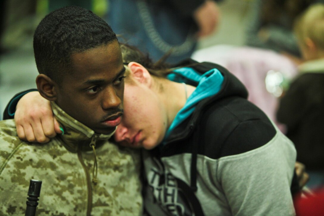 Lance Cpl. Travis McQueen, an information technology clerk with C-6, I Marine Expeditionary Force (Forward), from Euclid, Ohio spends time with loved ones moments before departing Camp Pendleton, Calif., Jan. 13. Nearly 140 of the I MEF (Fwd) command element’s 300 Marines and Sailors said goodbye to family and friends as they departed for Camp Leatherneck and Camp Bastion in Afghanistan.