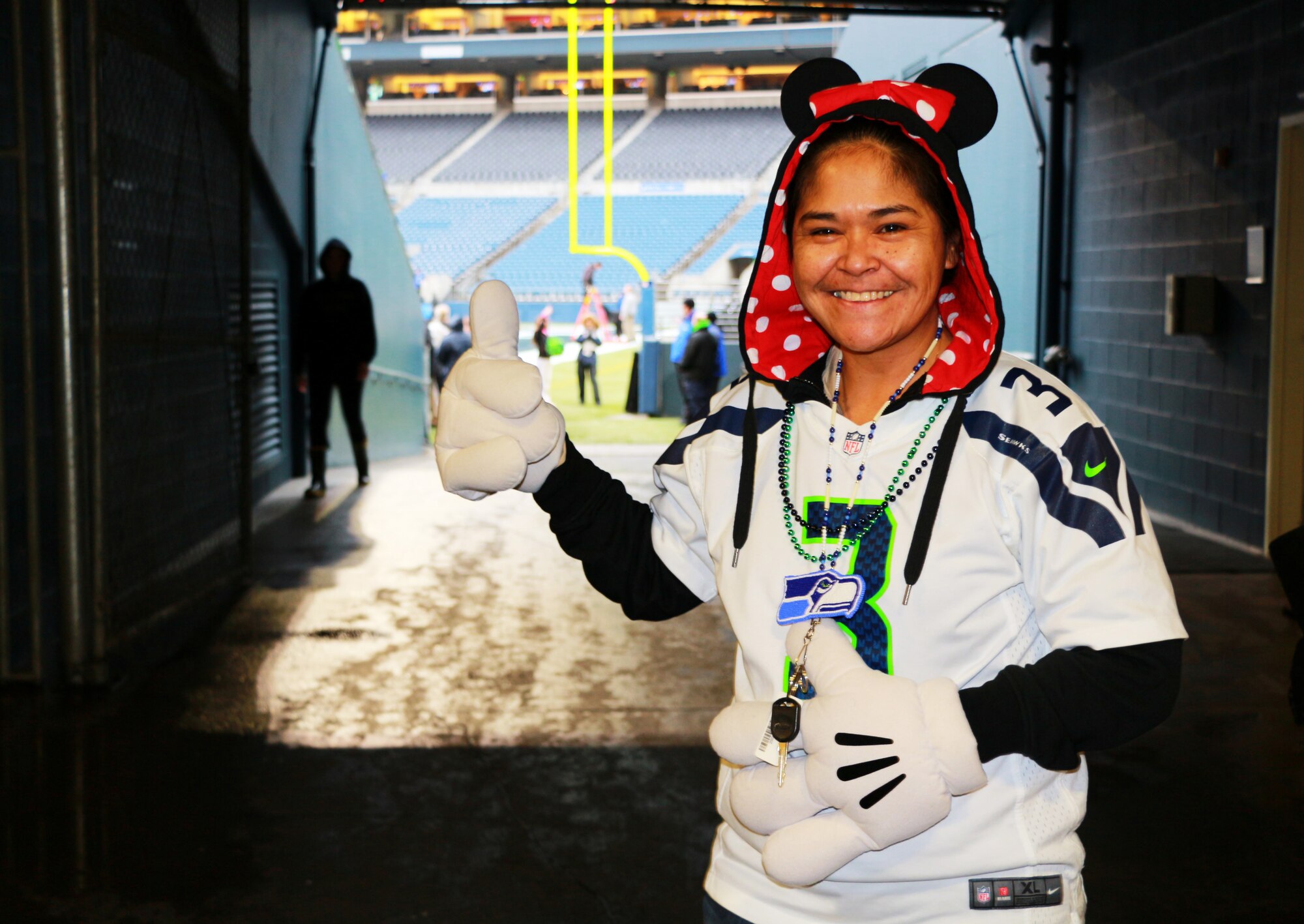 Senior Master Sgt. Emiliana Harris, 446th Aerospace Medicine Squadron, doesn’t let a little Pacific Northwest rain damper her “Spirit of the 12th Man” at the Seahawks game, Jan. 11 at Century Link Field in Seattle, Wash.  Harris, along with approximately 50 other service members, presented the US. flag during the pregame ceremonies and stayed for the game to cheer on the home team.  (U.S. Air Force photo by Senior Airman Madelyn McCullough)