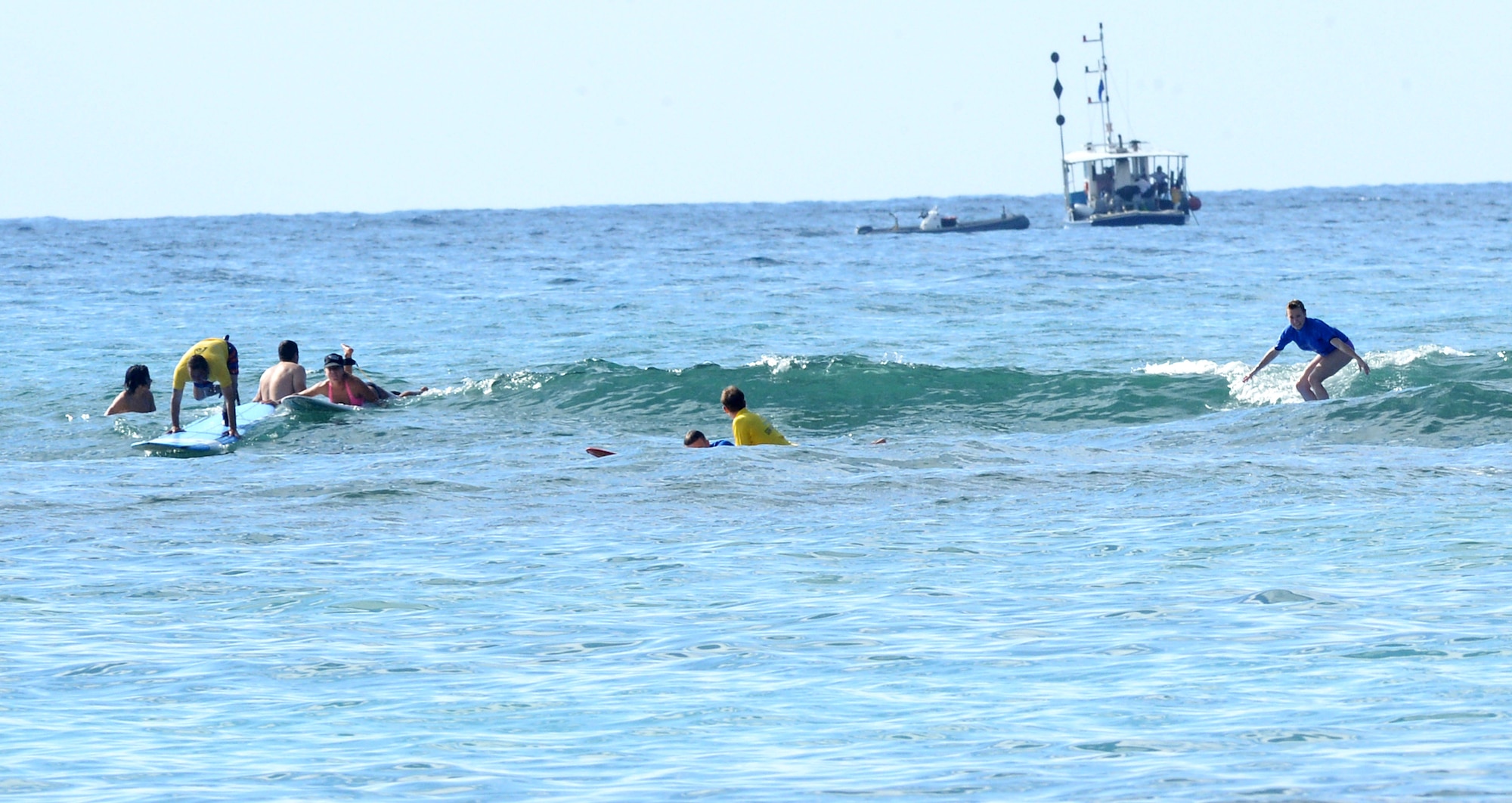 Wounded warriors and surf instructors catch some waves during an adaptive surf session at Waikiki Beach in Honolulu, Hawaii, Jan. 11, 2014. The session wrapped up a week of adaptive athletic competitions part of the Wounded Warrior Pacific Invitational. Athletic competitions included cycling, seated volleyball, swimming, track and field and wheelchair basketball. (U.S. Air Force photo/Staff Sgt. Alexander Martinez)