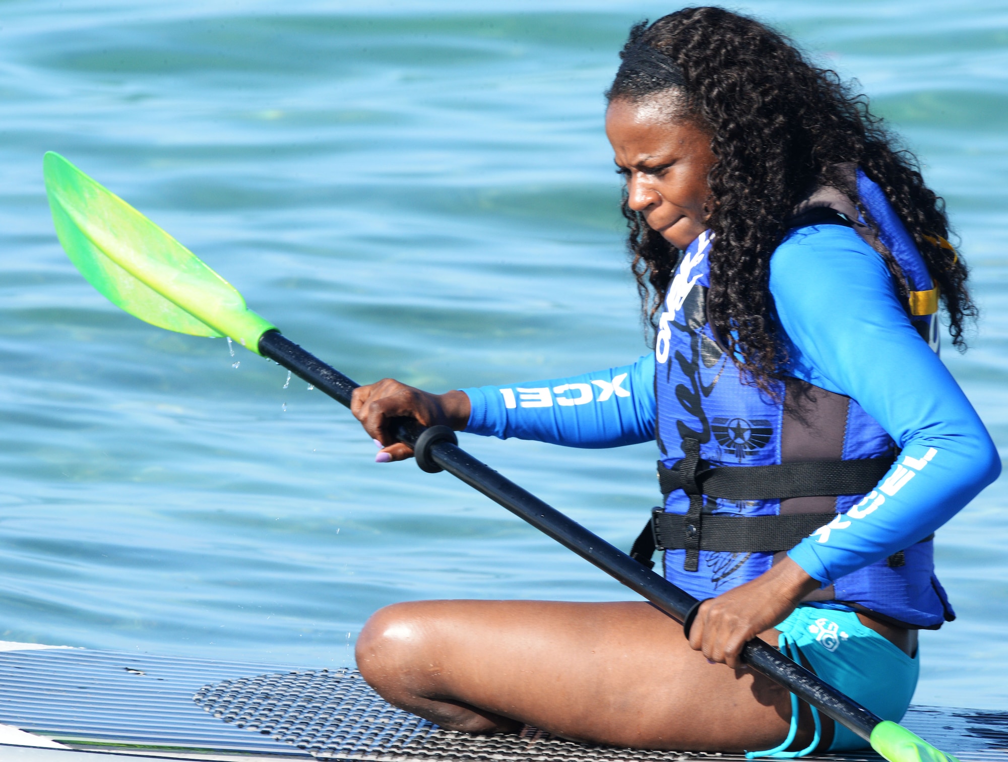 Retired Army Sgt. Kari Miller, a participant of the Wounded Warrior Program, paddles out to bigger waves during an adaptive surf session at Waikiki Beach in Honolulu, Hawaii, Jan. 11, 2014. The session wrapped up a week of adaptive athletic competitions part of the Wounded Warrior Pacific Invitational. Athletic competitions included cycling, seated volleyball, swimming, track and field and wheelchair basketball. (U.S. Air Force photo/Staff Sgt. Alexander Martinez)