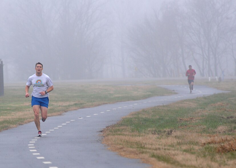 Maj. Walter Carroll, 2nd Bomb Wing commander's action group, races to the finish line of the New Year's Resolution 5K fun run on Barksdale Air Force Base, La., Jan. 10, 2014. Carroll's fitness goals for 2014 include getting a perfect score on the Iron Airman challenge, biking more than 5,000 miles and running more than 1,000 miles. (U.S. Air Force photo/Senior Airman Kristin High)
