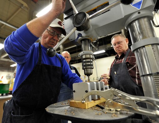 Dave Hudson, 92nd Force Support Squadron woodcraft staff, uses the drill press in the wood craft center at Fairchild Air Force Base, Wash., Jan. 13, 2014. Hudson is making a wooden pen for the course held at the shop. (U.S. Air Force photo by Airman 1st Class Ryan Zeski/Released)