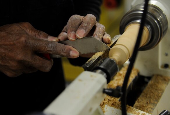 A student at the wood craft center uses the lathe to shave down a dowel for his project at Fairchild Air Force Base, Wash., Jan. 10, 2014. Once students are trained on a machine they are able to use it without supervision. (U.S. Air Force photo by Airman 1st Class Ryan Zeski/Released)
