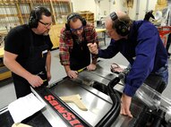 Kevin Watt, 92nd Force Support Squadron woodcraft instructor, explains proper safety measures on the table saw at the wood craft center at Fairchild Air Force Base, Wash., Jan. 10, 2014. The students are part of the woodworking one course, covering the basics of wood crafting. (U.S. Air Force photo by Airman 1st Class Ryan Zeski/Released)